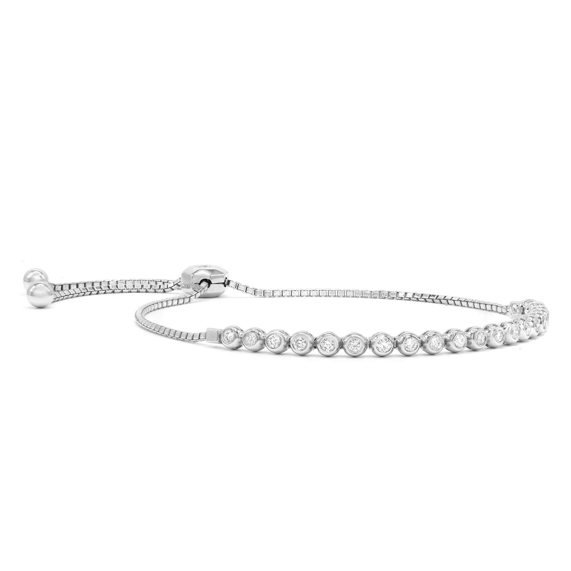 Trendy tennis bracelet with a sliding lariat closure on a delicate box chain. Super comfortable, so easy to wear! The design is shimmered with 22 bezel set round brilliant cut diamonds totaling 0.68 carats crafted in fine 14K White Gold. Good