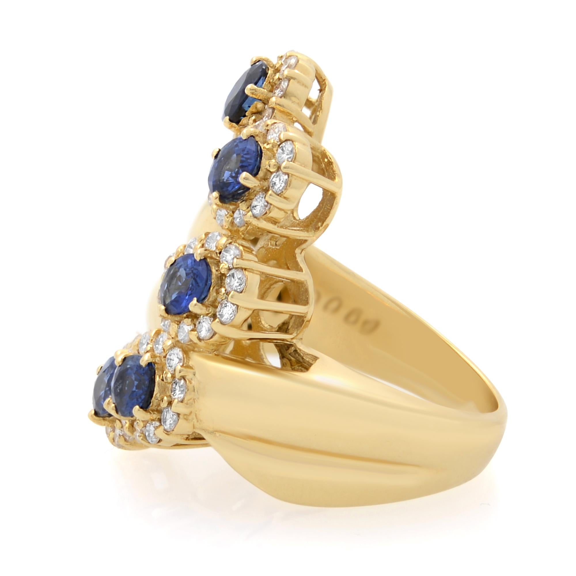 This stunning cocktail ring comes with a flashy statement look. A must have in your jewelry collection. The ring is crafted in 18K yellow gold. Featuring oval cut blue Sapphires weighing 1.89cttw surrounded with round brilliant cut diamonds weighing