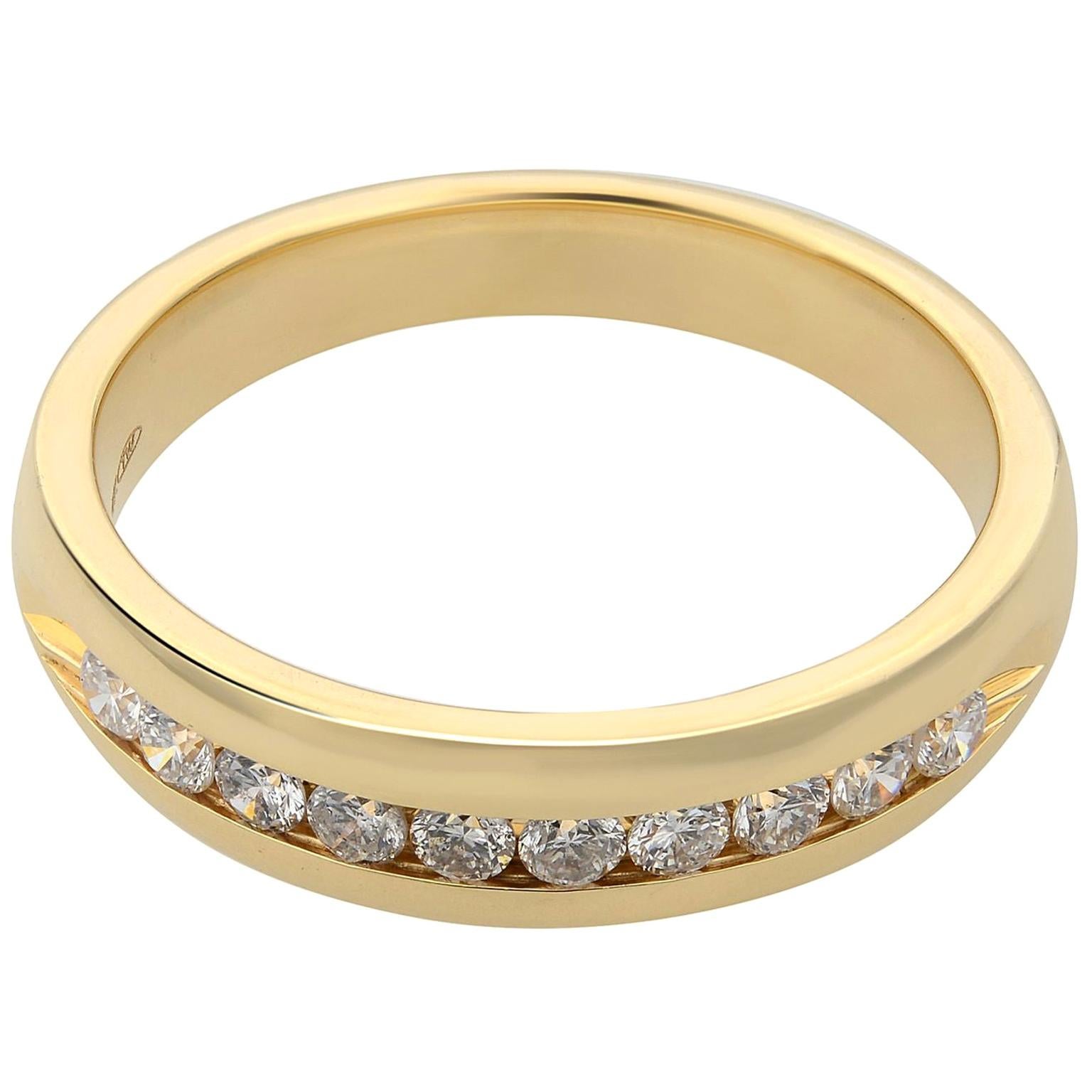 This 14k yellow gold Men's wedding band is 5.50mm wide and features 10 round cut diamonds in a channel setting. The ring has a high polished satin finish and rounded edges for a comfort-fit. Approximately 0.66 carat total diamond carat weight.