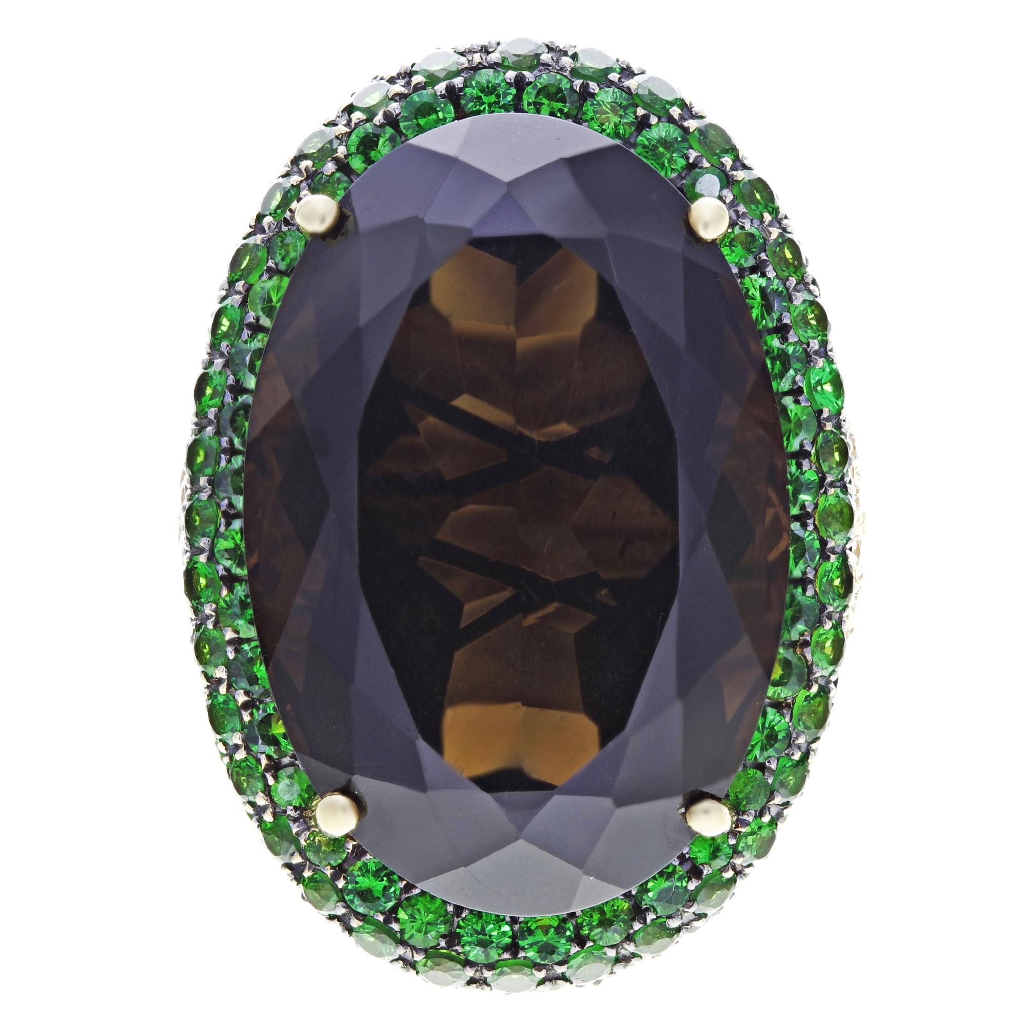 This is a glamorous cocktail ring crafted in 18K carat yellow gold. It features a madeira citrine stone 27 x 19mm, surrounded by sparkly pave diamonds 3.10cts and Green Tsavorites (Garnet) round cuts: 3.24cts. This ring will give you the most