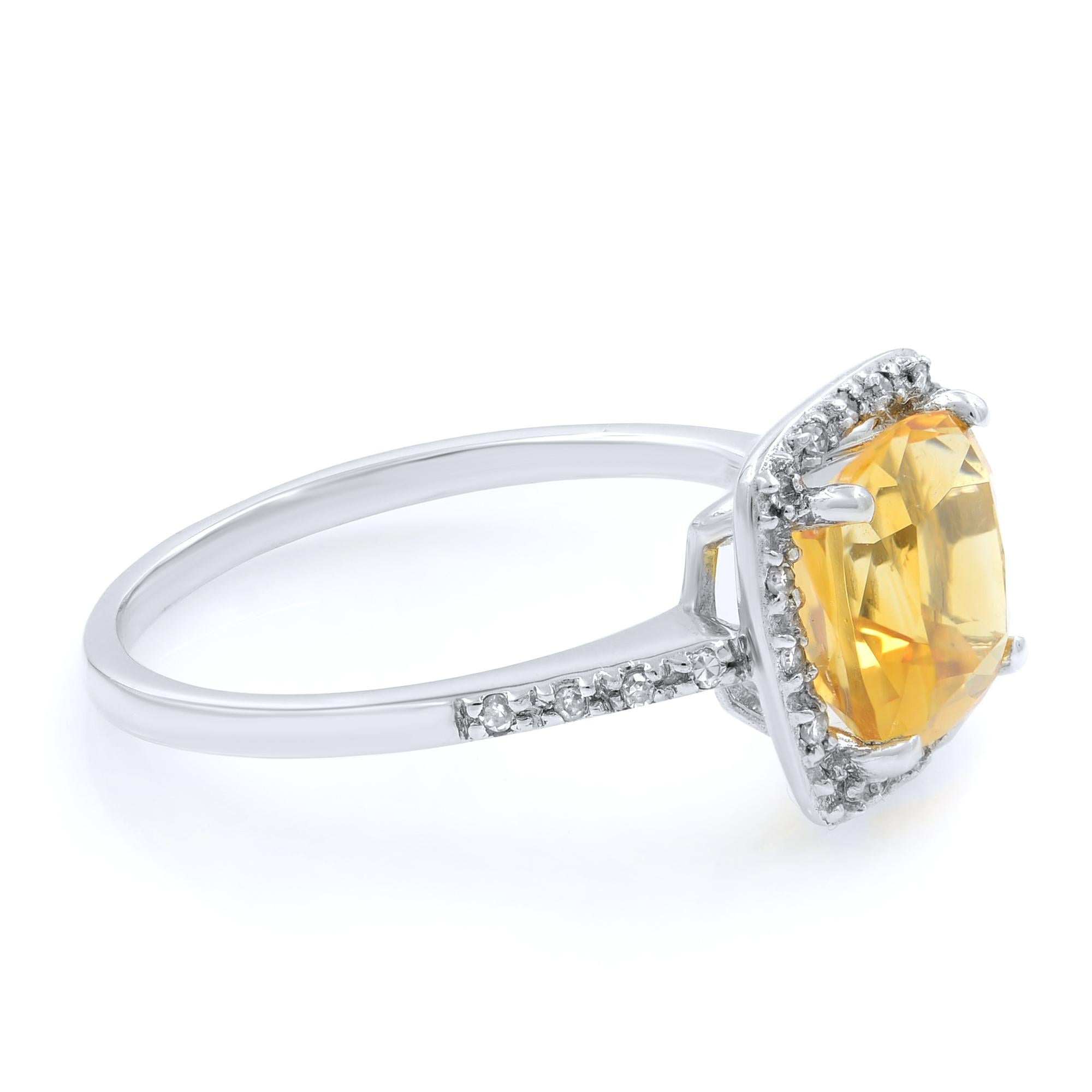 This gorgeous engagement ring is crafted in 14k white gold. The cushion cut citrine weighing 2.7cttw is illuminated by a sparkling halo of diamonds. To complete the brilliant allure, there are additional diamond accents on the shoulders of this