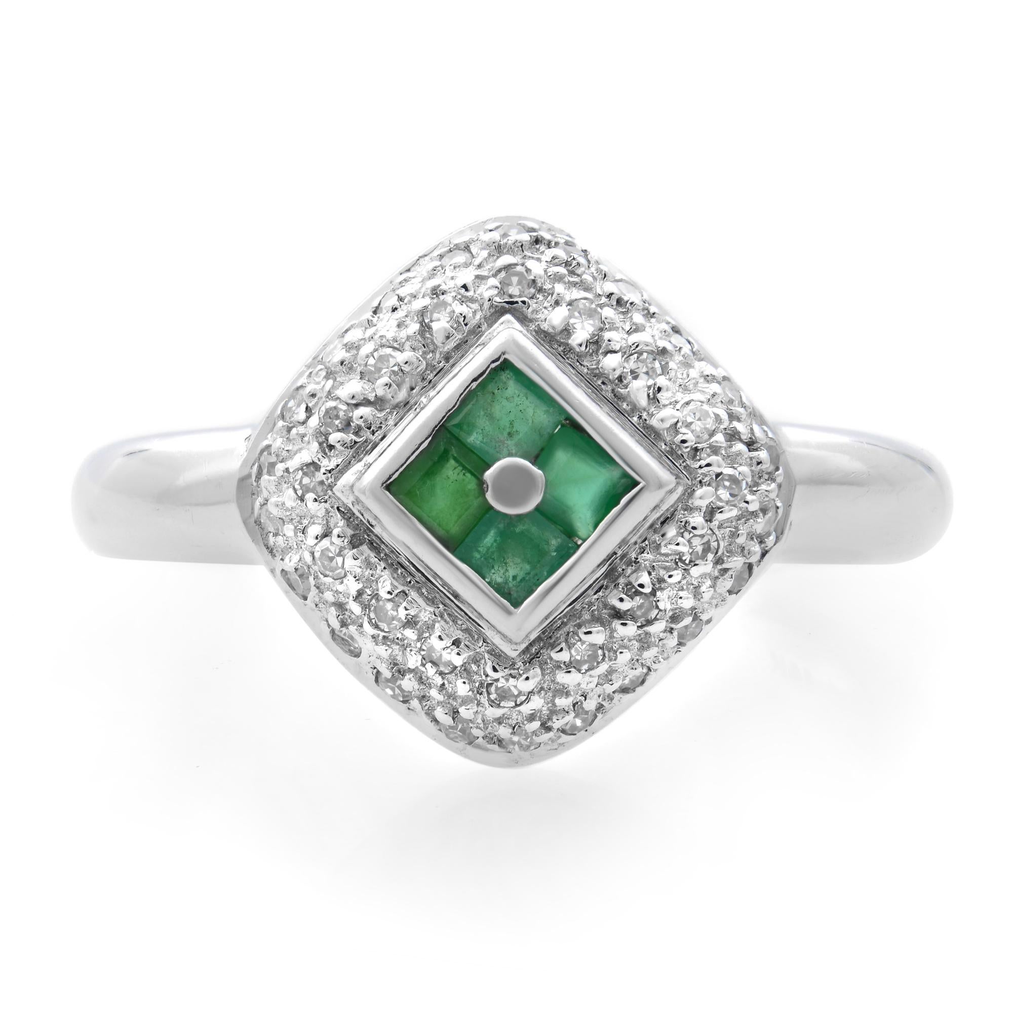This beautiful ladies ring is encrusted with 4 princess cut Green Emeralds weighing 0.20 carat and pave set round cut diamonds weighing 0.10 carat. Crafted in 14k white gold. Ring size: 6.5. Total weight: 3.66 grams. Great pre-owned condition. Comes