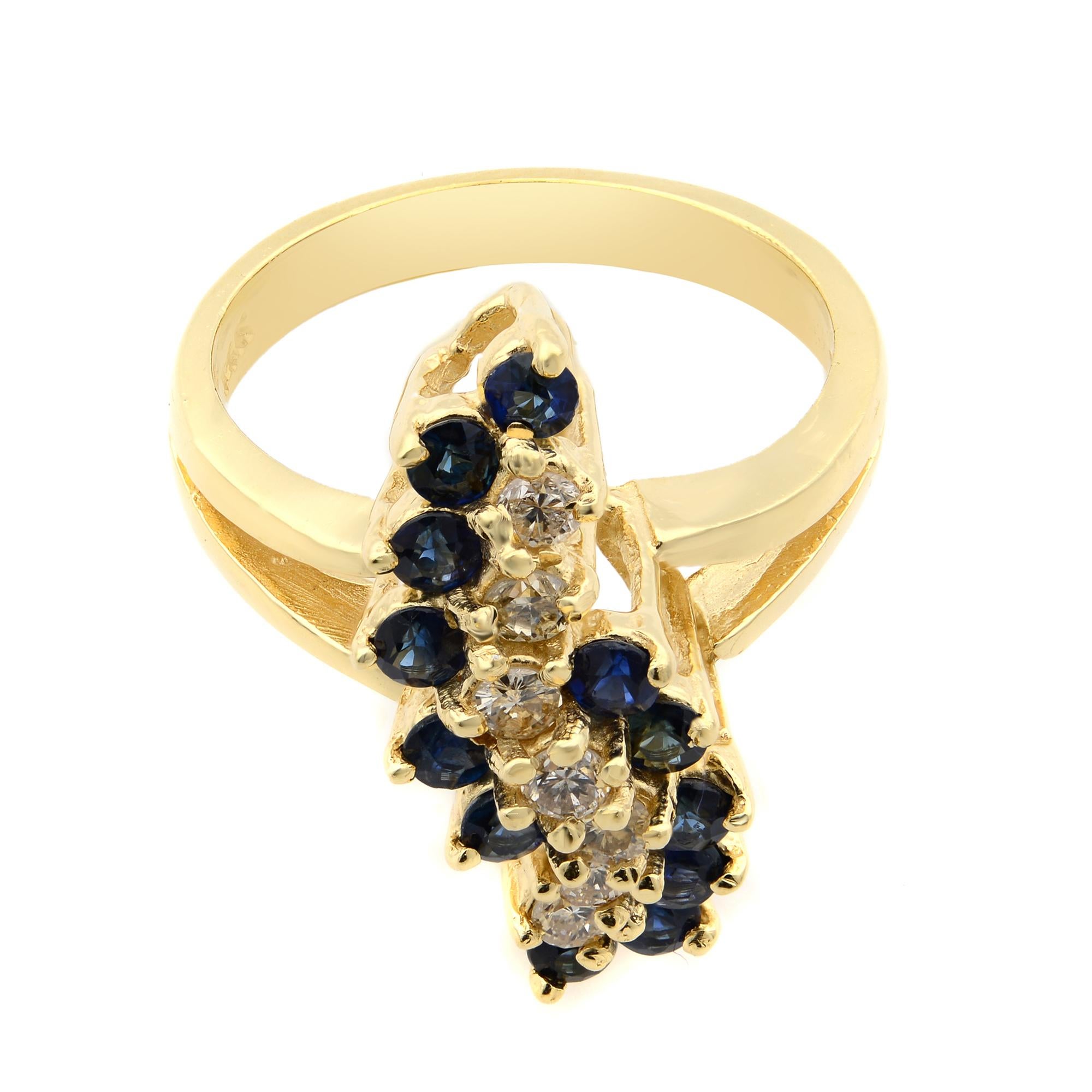 This stunning cocktail ring comes with a flashy statement look. A must have in your jewelry collection. Crafted in 14k yellow gold. It features a center row of round brilliant cut diamonds flanked with round cut blue sapphires on both sides in prong