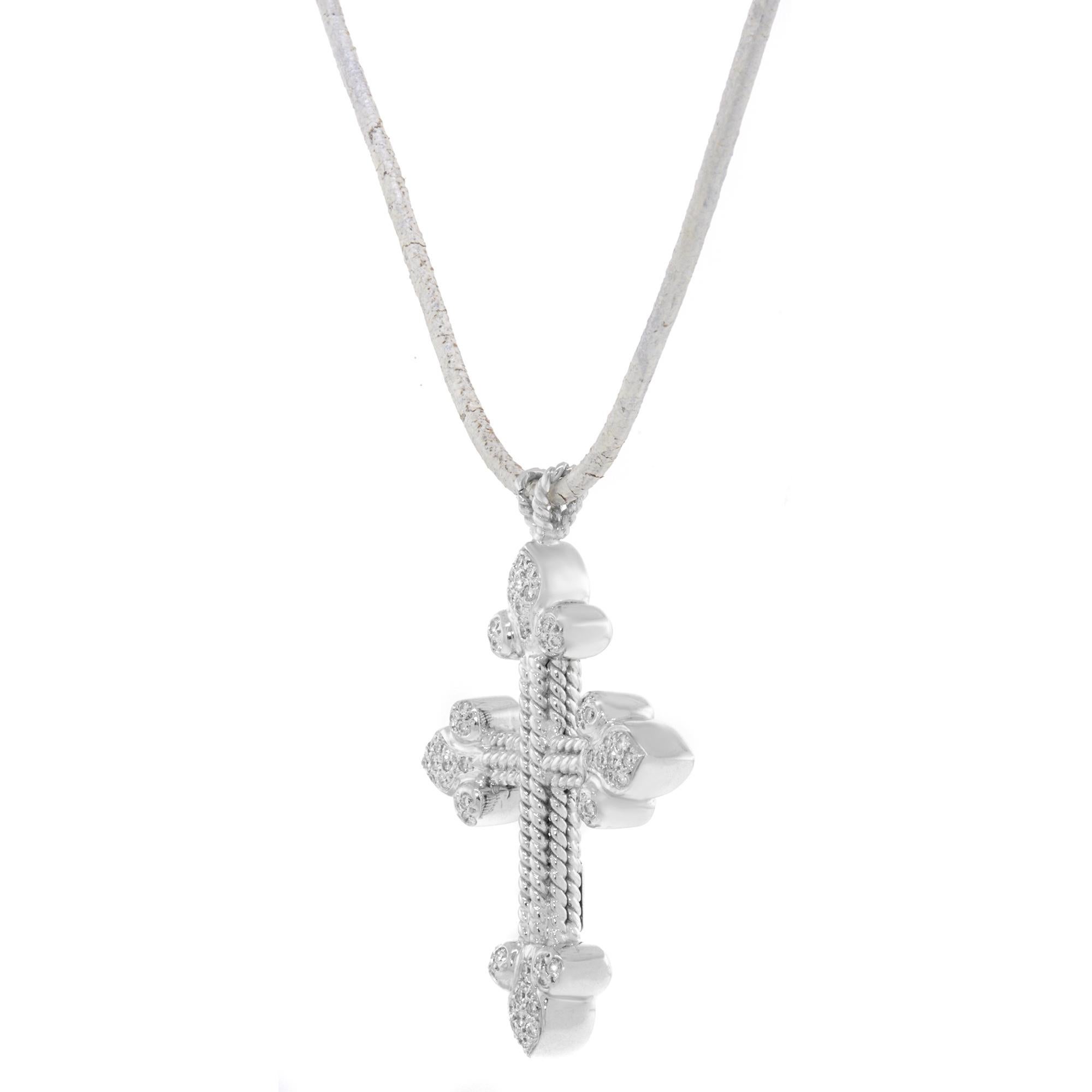 This beautiful cross necklace is crafted in 18k white gold and encrusted with 56 round cut diamonds. The length of the necklace is 41cm / 20cm. Total weight: 27 gms. The rope might have blemishes due to wear and age. The necklace comes with a gift