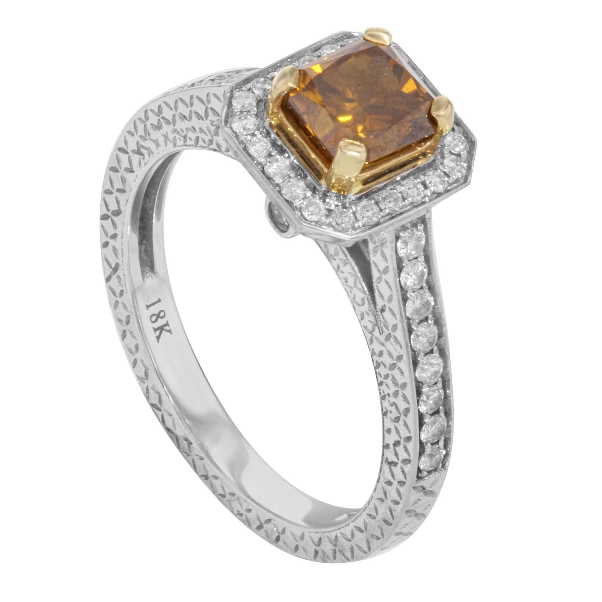 This beautiful diamond engagement ring is crafted in 18K white & yellow gold. It features a center prong set radiant cut color treated cognac diamond stone weighing approx. 1.00 carat with pave set round cut diamond accents weighing approx. 0.50ct.