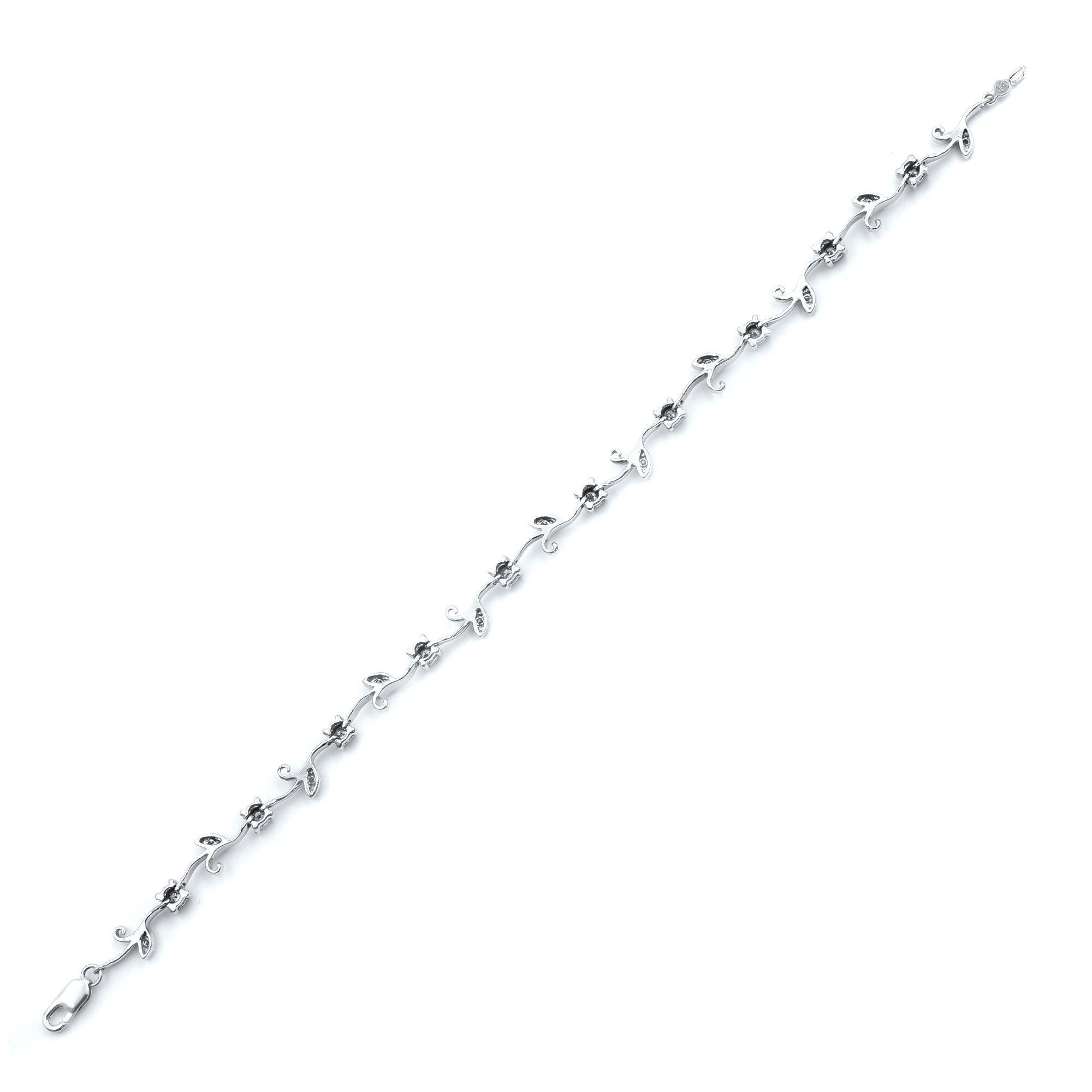 Sparkling diamond floral bracelet crafted in 14k white gold, featuring round brilliant cut diamonds. Total diamond weight is approximately 0.25cts. Closure: lobster lock. Bracelet length: 7 inches. Comes in a presentable gift box. 