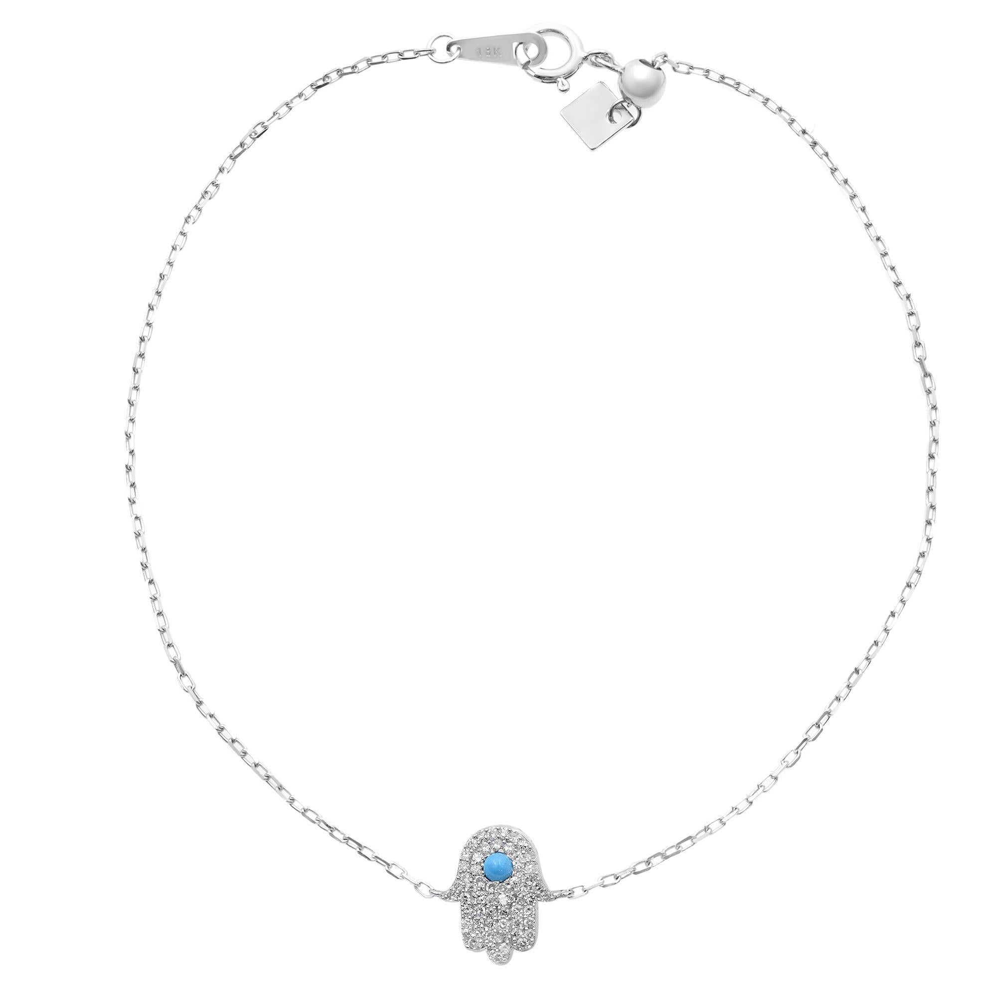 Classic and timeless hamsa bracelet, crafted in 14k white gold comes with center stone turquoise surrounded by round cut pave set white diamonds weighing 0.15cttw, anchored with delicate 7.5 inches 14k white gold chain. This bracelet is available in