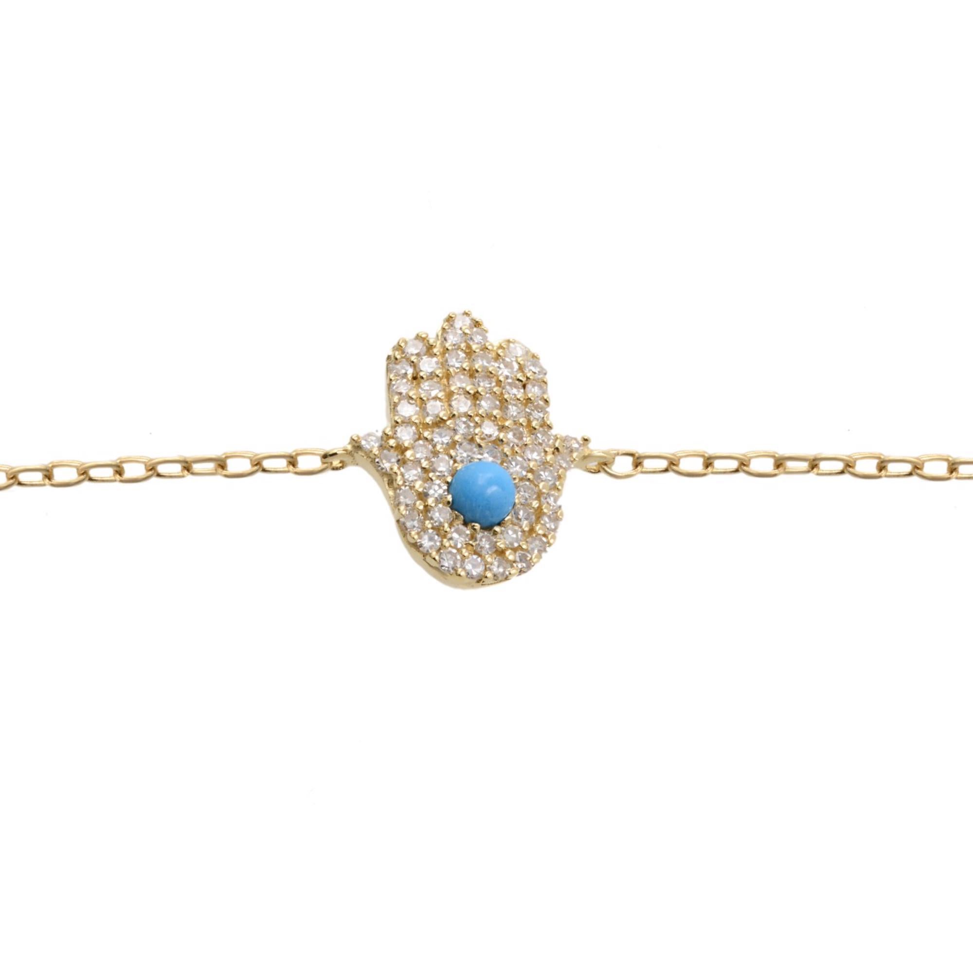 Classic and timeless hamsa bracelet, crafted in 14k yellow gold comes with center stone turquoise surrounded by round cut pave set white diamonds weighing 0.15cttw, anchored with delicate 7.5 inches 14k yellow gold chain. This bracelet is available