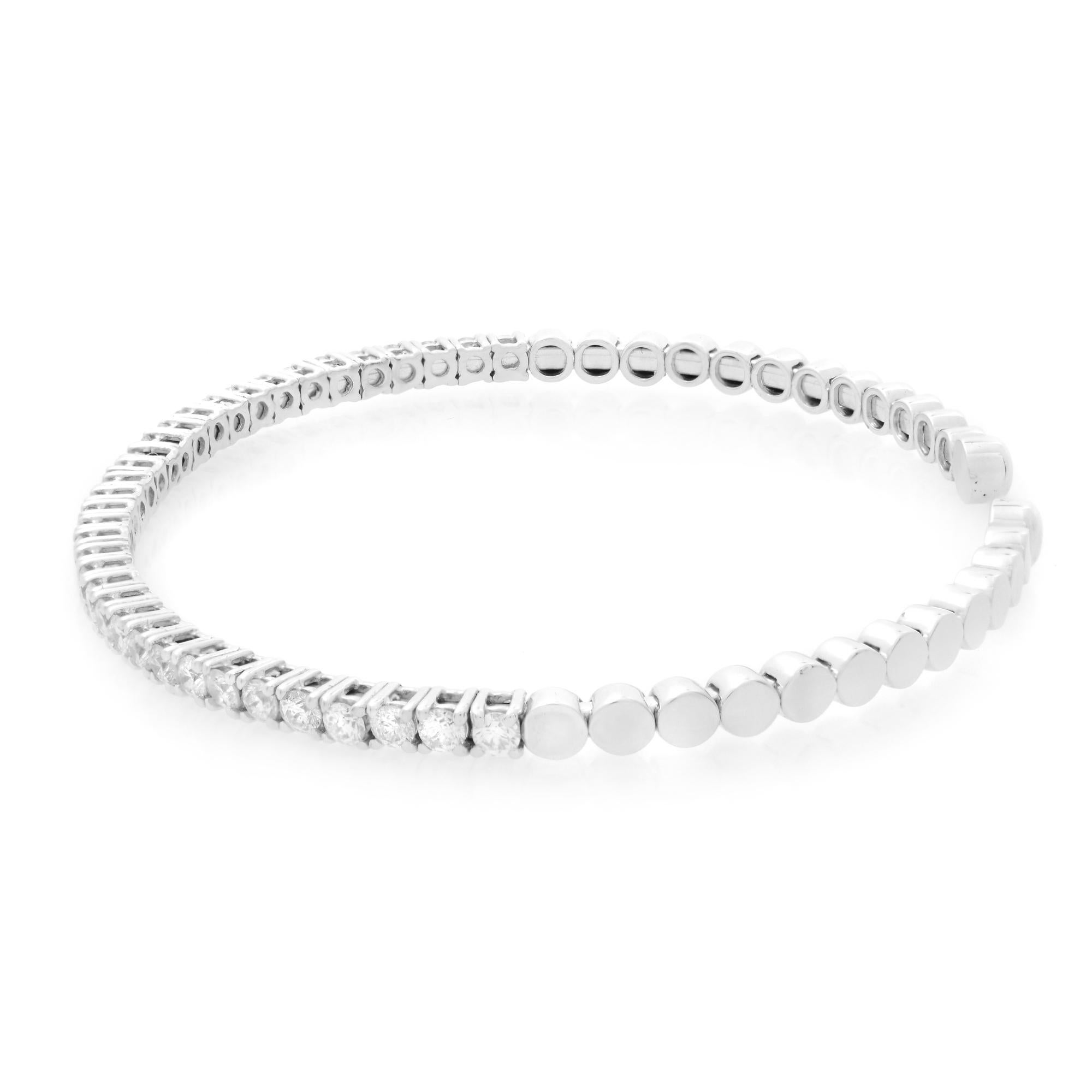 14K white gold diamond cuff bangle bracelet. This solid gold fashion bracelet features 1.88 carat of prong set round diamonds. Color I and SI-I clarity. Solid  white gold high polished circles finish the bracelet. This flexible style bracelet
