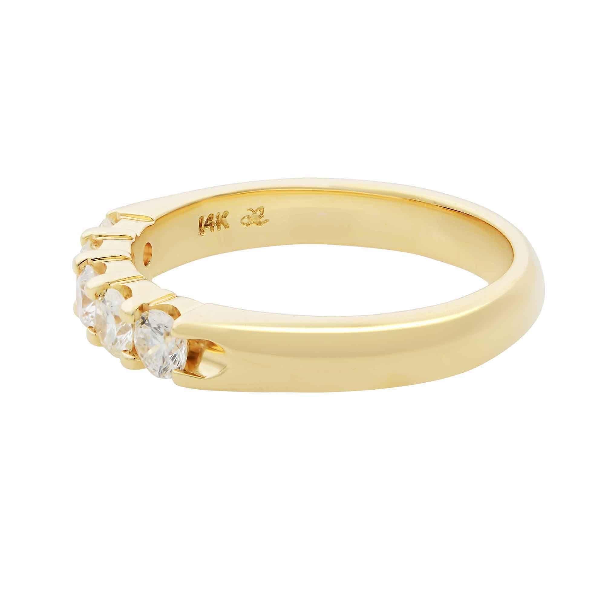 \Five sparkling round cut diamonds are secured in prong setting on this 14k yellow gold band. Exhibiting a half eternity design, this timeless wedding band symbolizes eternal love. Total diamond carat weight is 0.50. Diamonds are VS1 clarity and G