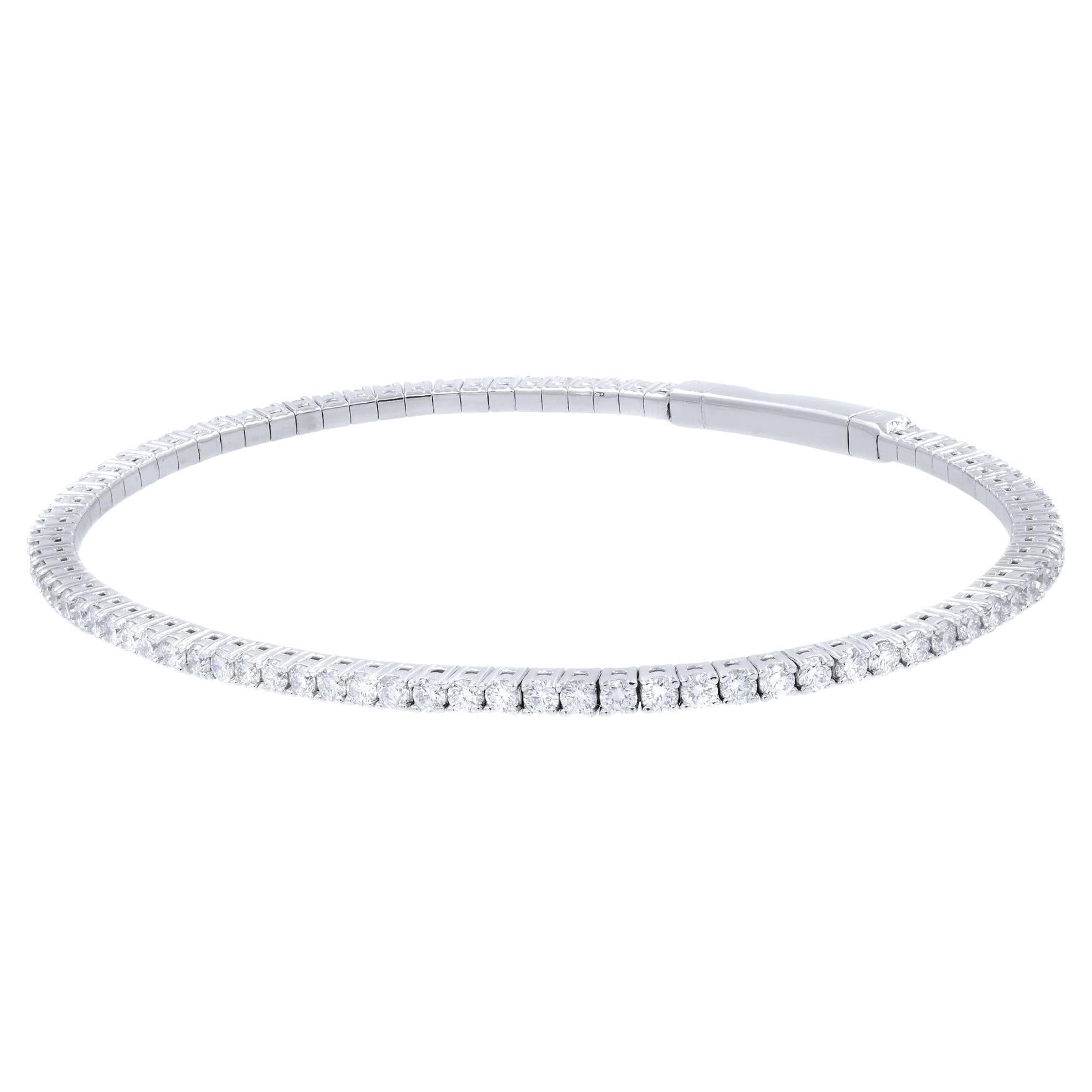 A classic look with easy elegance, this diamond bangle  exudes sophistication. One stunning flexible bangle bracelet in 14K white gold, prong-set with fine white diamonds with a total weight of 1.50cts. The bangle measures 1.8mm in width and weighs