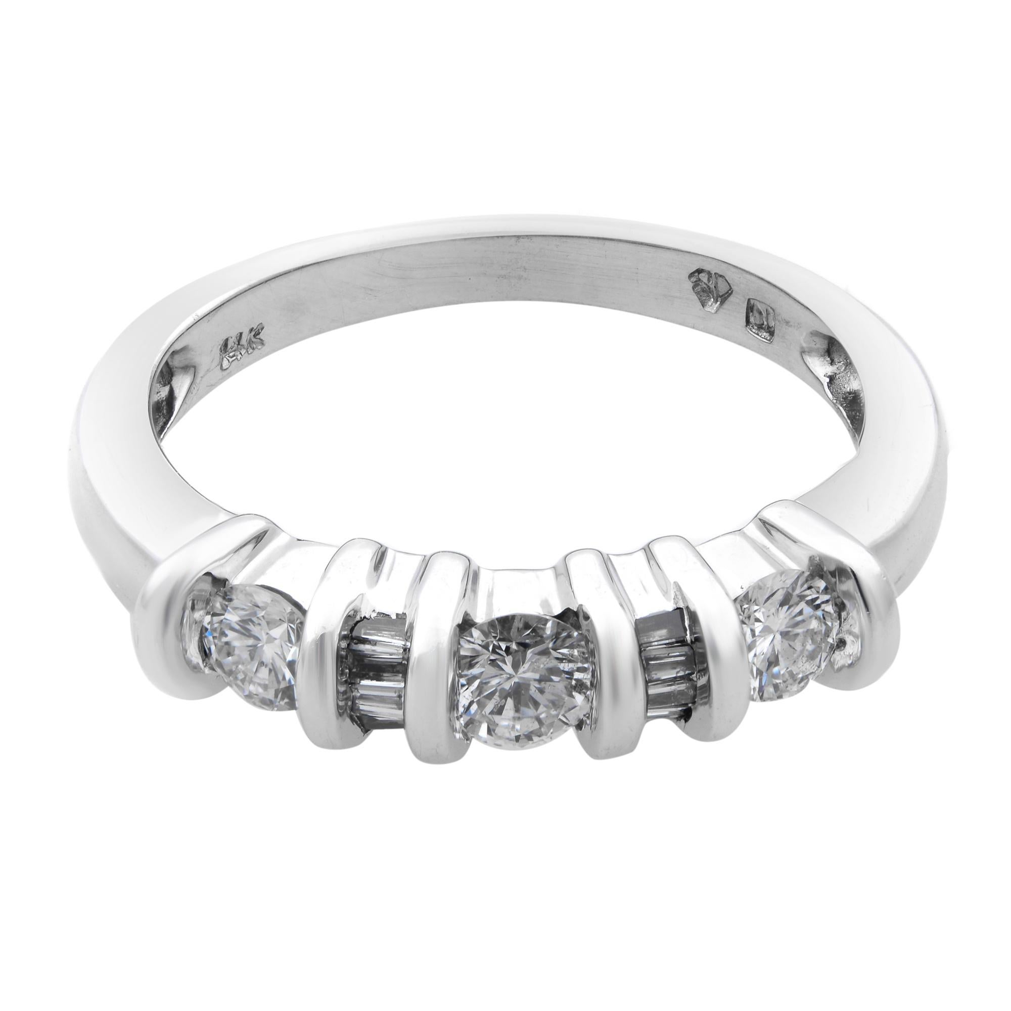 This beautiful ladies wedding band ring is crafted in 14k white gold. It features an invisible setting of round and baguette diamonds weighing 0.5cttw. Diamond quality: SI1 - clarity; G - color. Ring size: 7. Total weight: 3.6 gms. Comes with the