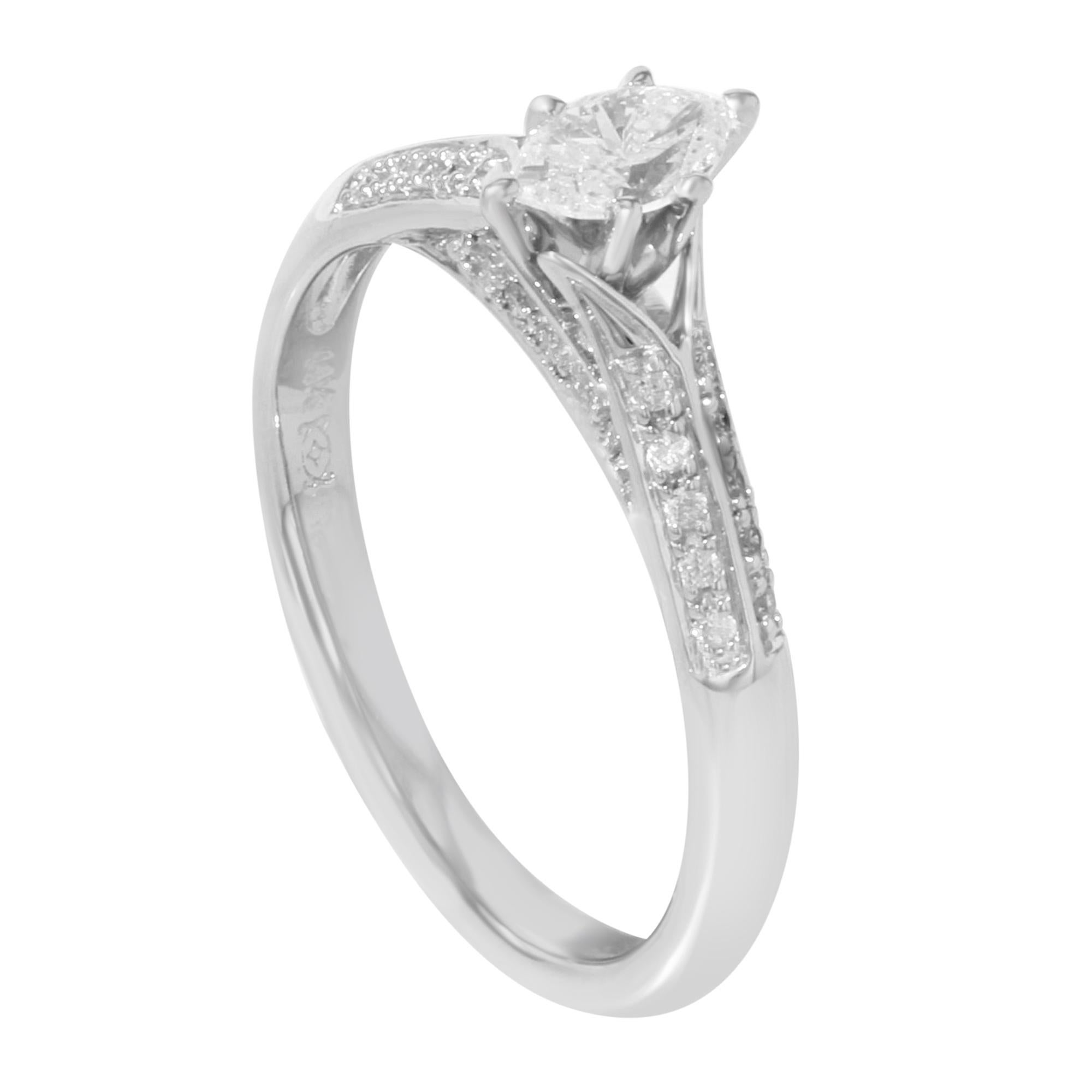 This elegant and alluring ladies' engagement ring is crafted in 14k white gold. Featuring, center prong set marquise cut white diamond with pave set round cut white diamond accents. Total diamond weight: 0.75ct. Ring size 7.25. Total weight: 3.2