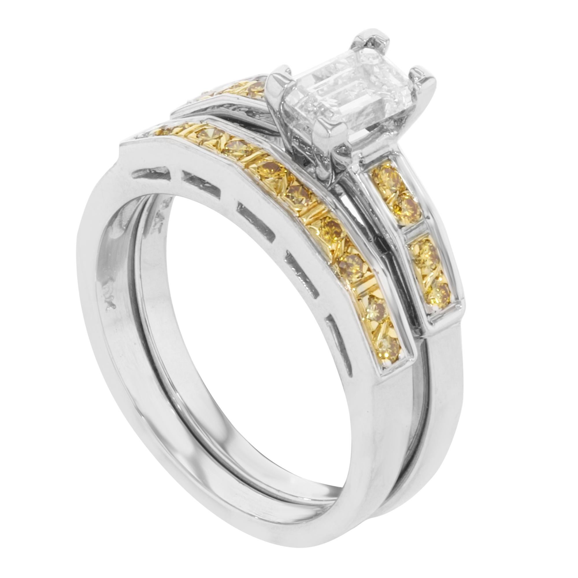 This 2 piece engagement ring set is crafted in 18K yellow gold and platinum. Center emerald cut diamond weighs approx. 0.66 cttw. Accent stones are round cut yellow diamonds weighing approx. 1.65 cttw. Wedding band is encrusted with 10 round cut