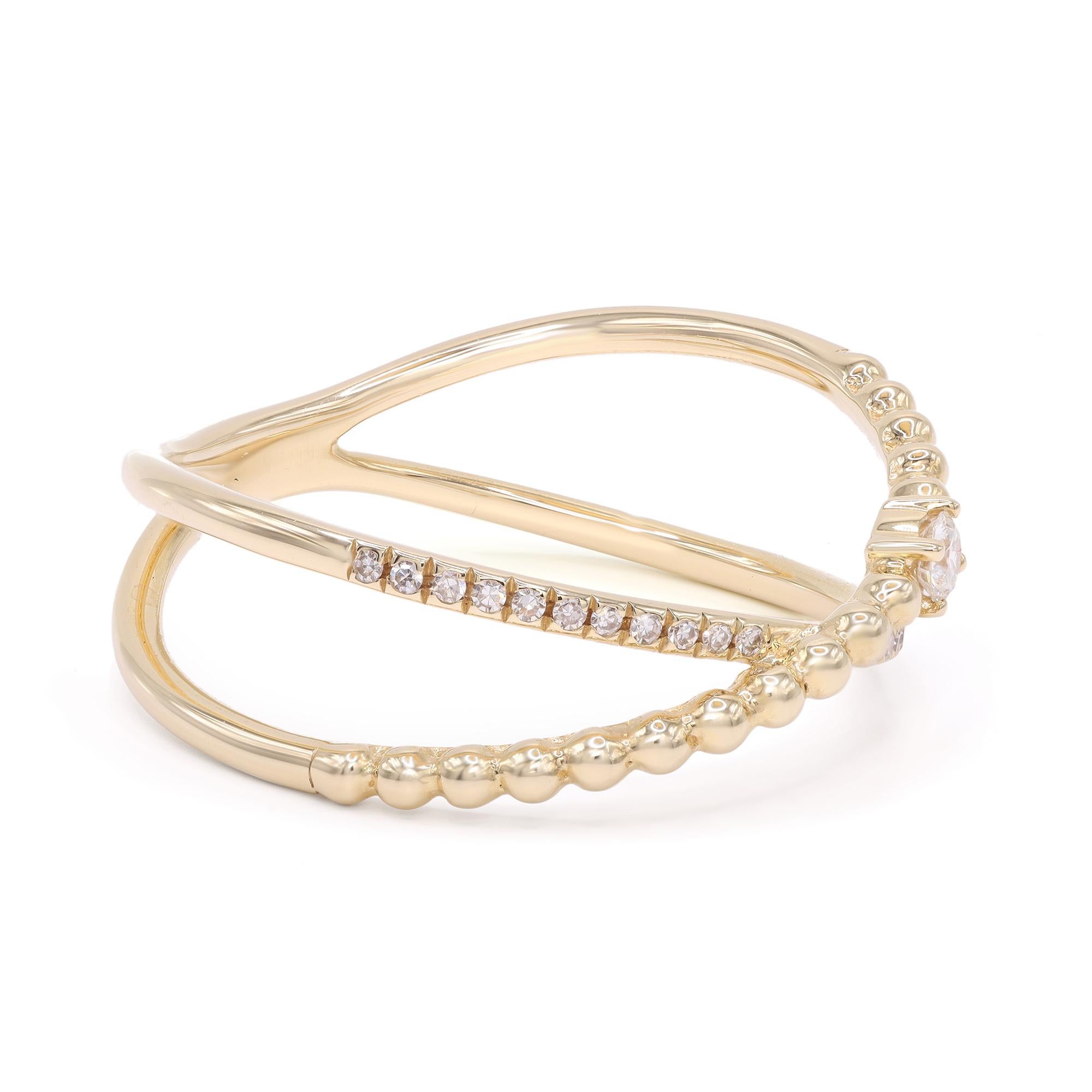 This beautiful 14k yellow gold X ring is accented by a petite line of pave round cut diamonds along with a gold bead line featuring a single round cut diamond. The total diamond carat weight is 0.12. Diamond color G-H and VS-SI clarity. Ring size 7.