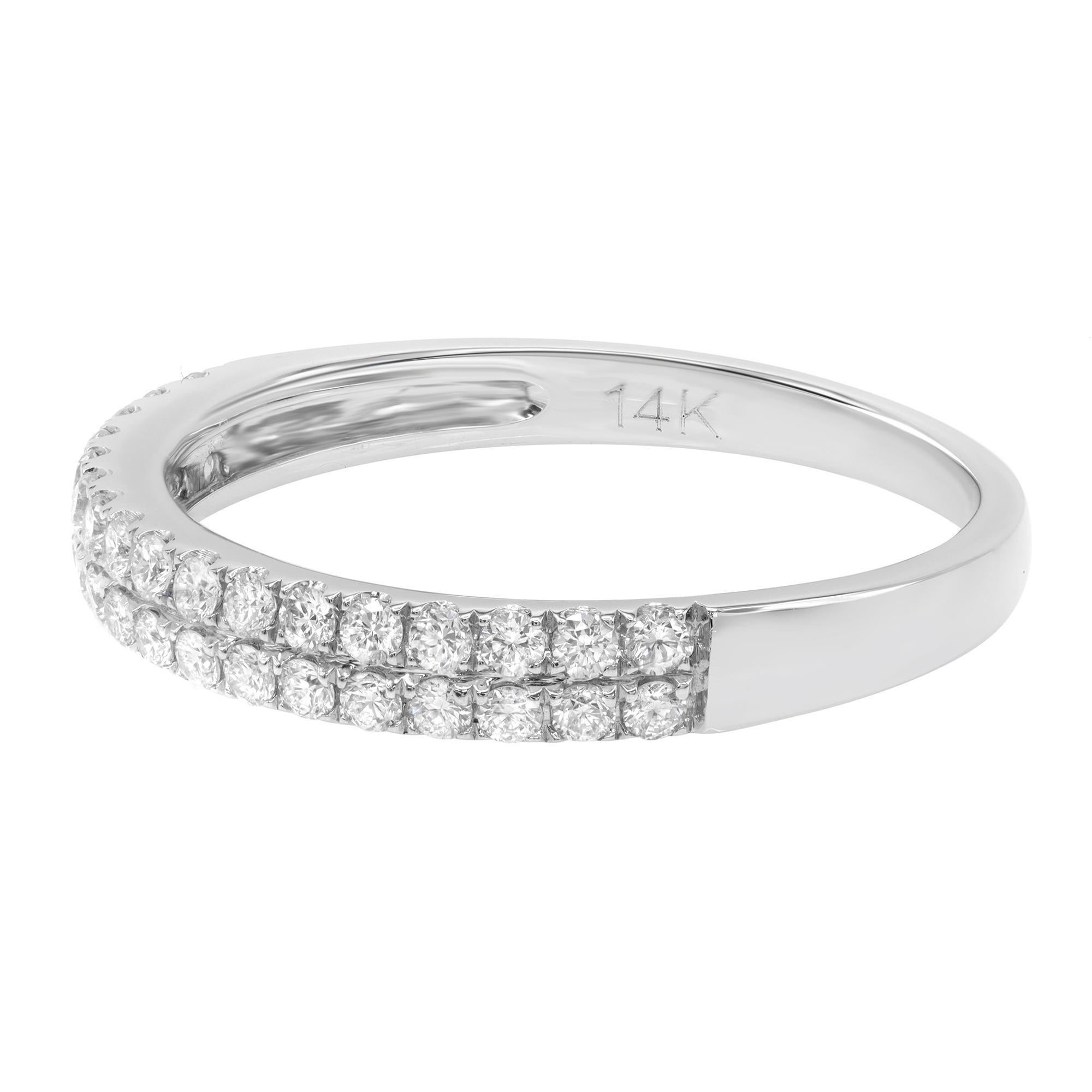 This 14 karat white gold wedding band features 34 sparkling round pave set diamonds at approximately 0.37 carat total weight. Each stone has been hand-matched to display consistent fire and brilliance. Diamond color G-H and VS-SI clarity. The band
