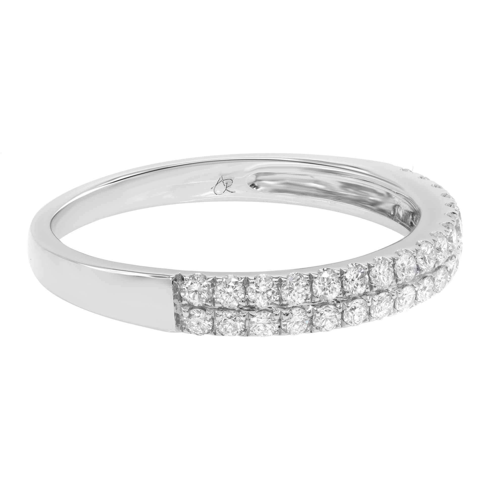 This 14 karat white gold wedding band features 34 sparkling round pave set diamonds at approximately 0.37 carat total weight. Each stone has been hand-matched to display consistent fire and brilliance. Diamond color I and SI-I clarity. The band