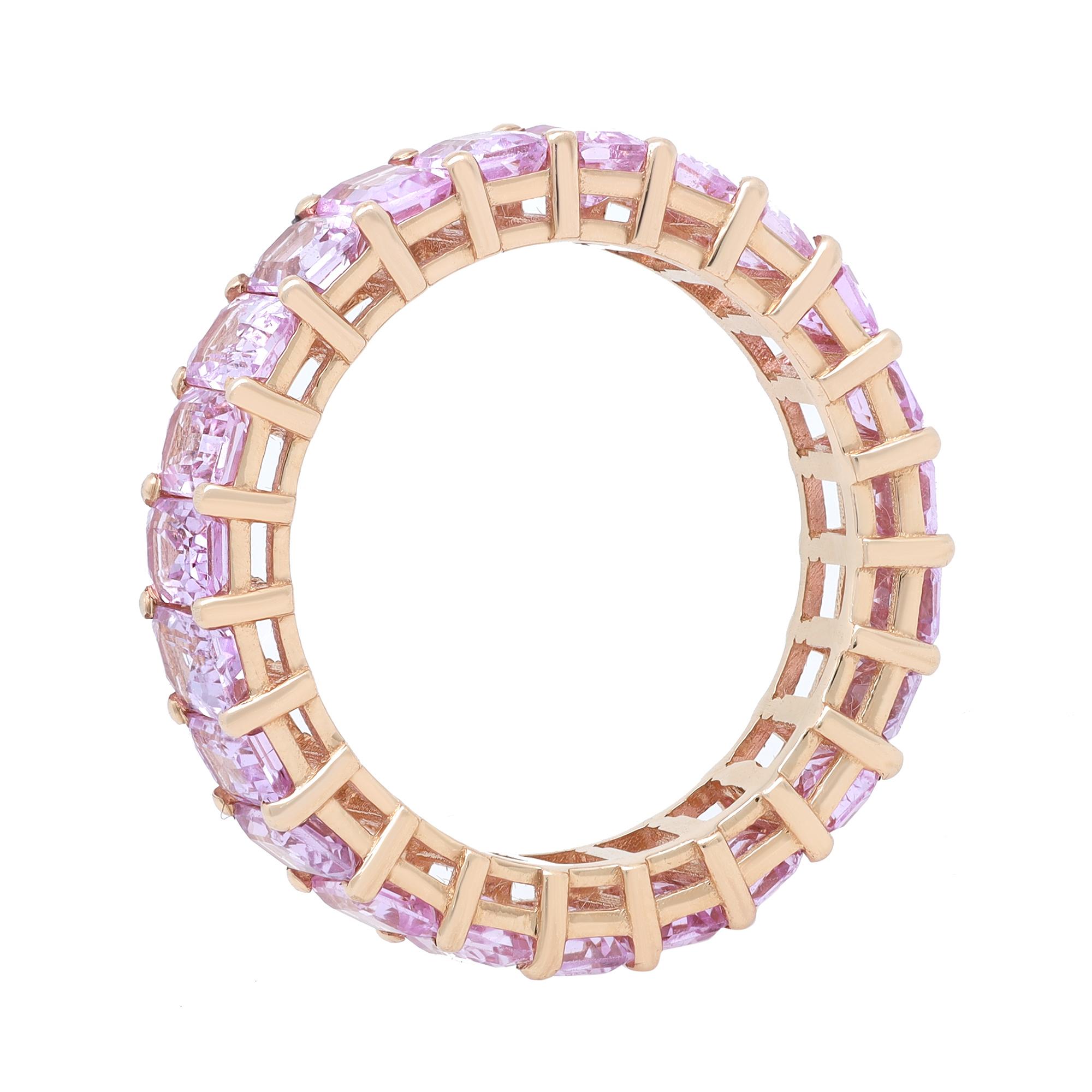 A sweet token of eternal love to your beloved. This exquisite Pink Sapphire eternity band ring is crafted in fine 14K yellow gold. It features 23 prong set Emerald cut Pink Sapphires weighing 6.12 carats. With their medium and vivid tone, the
