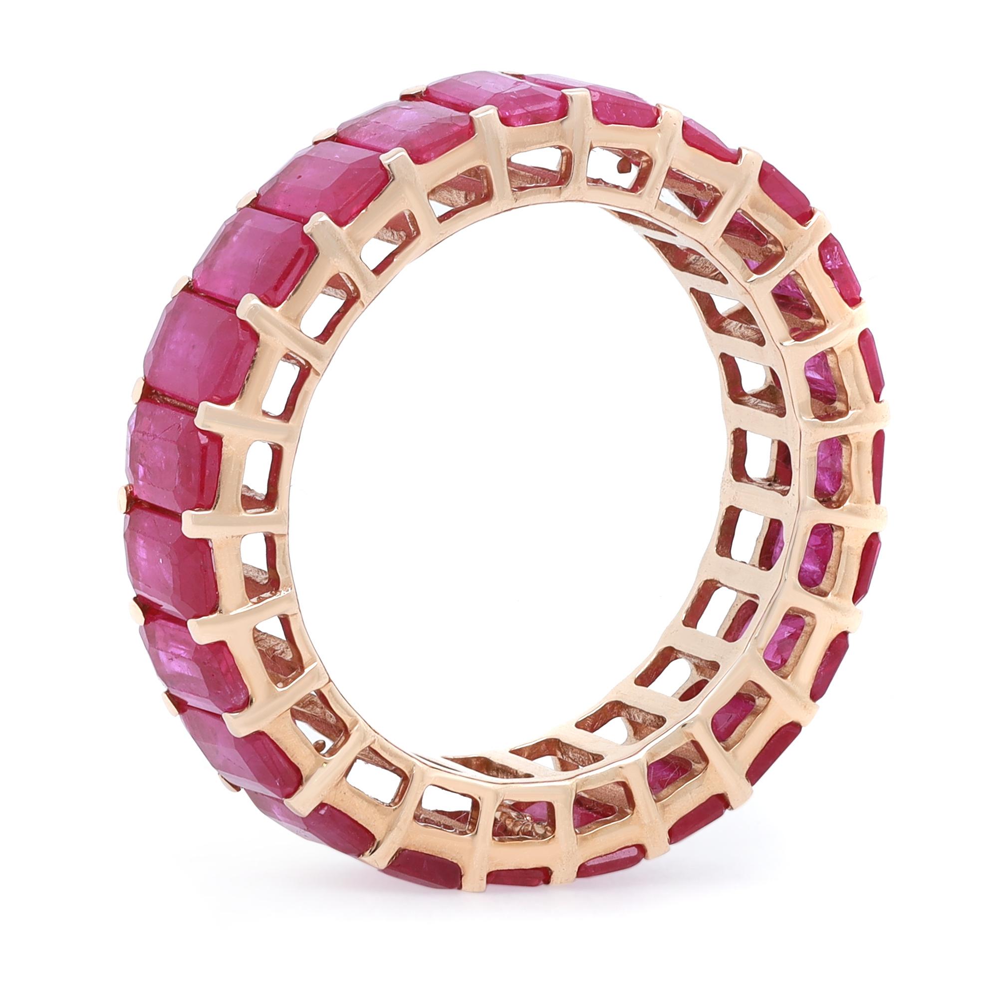 This classic timeless eternity band is a perfect stackable ring. Enchanting and irresistibly striking, this ring is beautifully crafted in fine 14K yellow gold. It features 23 prong set Emerald cut Rubies weighing 6.92 carats. A sweet token of