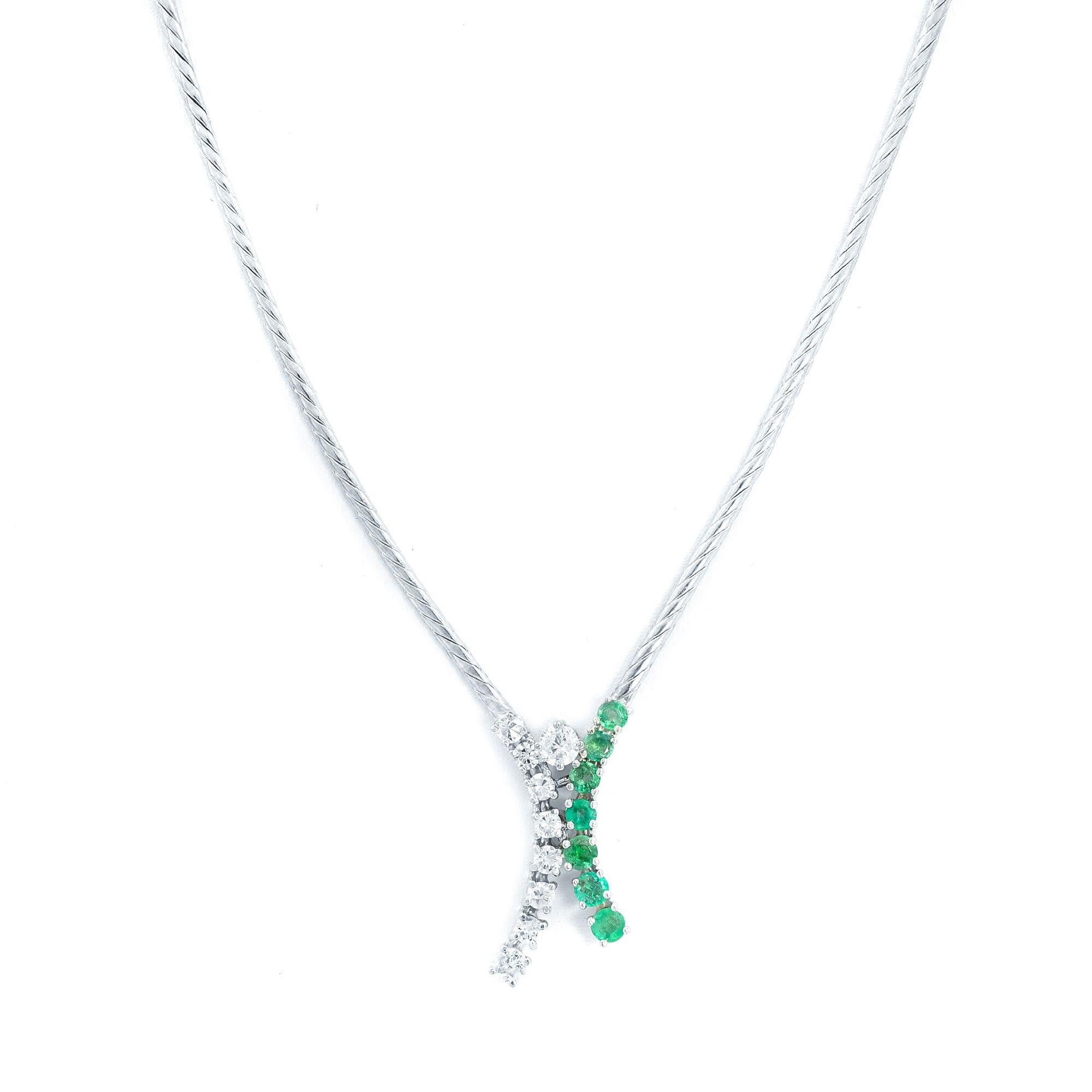 Chic and Trendy diamond emerald necklace hand fabricated in 14k white gold. This necklace features prong set 7 round cut emeralds with 9 round cut diamonds. Chain length: 16 inches. Comes with a presentable gift box.