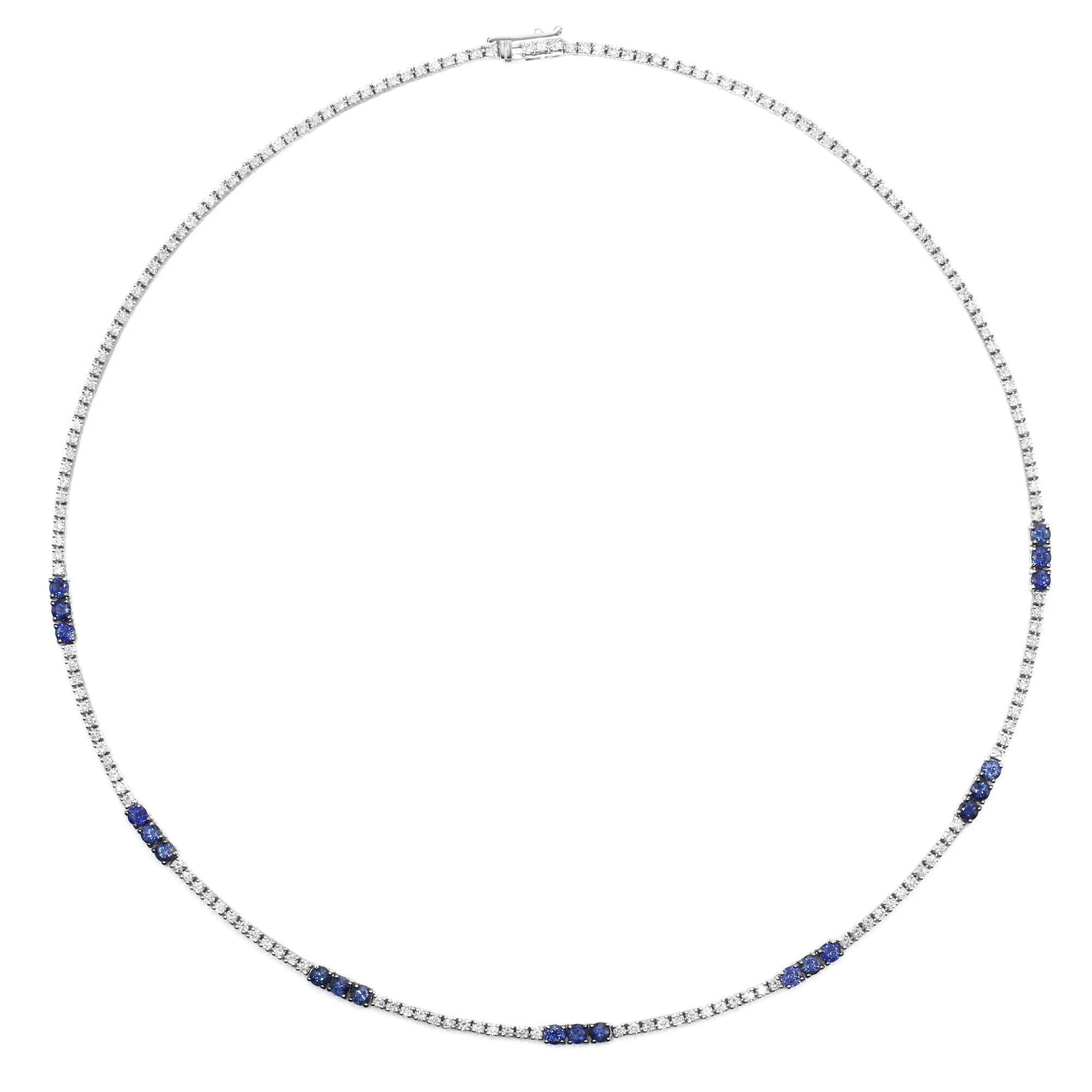 This stunning tennis necklace features round cut white diamonds and blue sapphires. All stones are prong set in 14k white gold. The necklace is secured by a locking clasp. Length: 17 inches. Width: 2.80mm. Total Sapphires weight: 2.29ct. Total