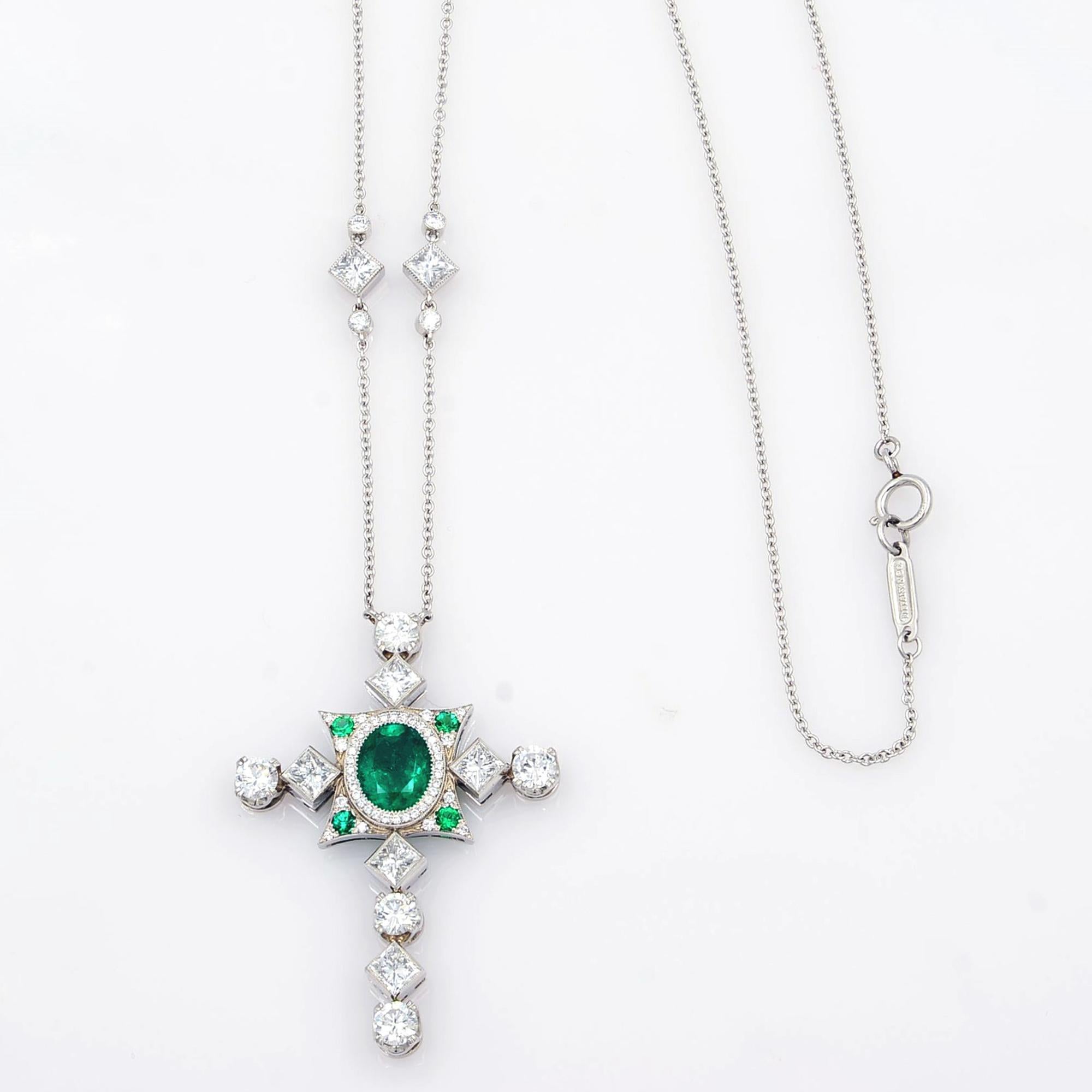 This gorgeous necklace features timeless beauty and superlative craftsmanship with a striking stylized cross beautifully crafted in platinum and placed on a diamond by the yard chain. A romantic jewel for your neck with glorious green and white