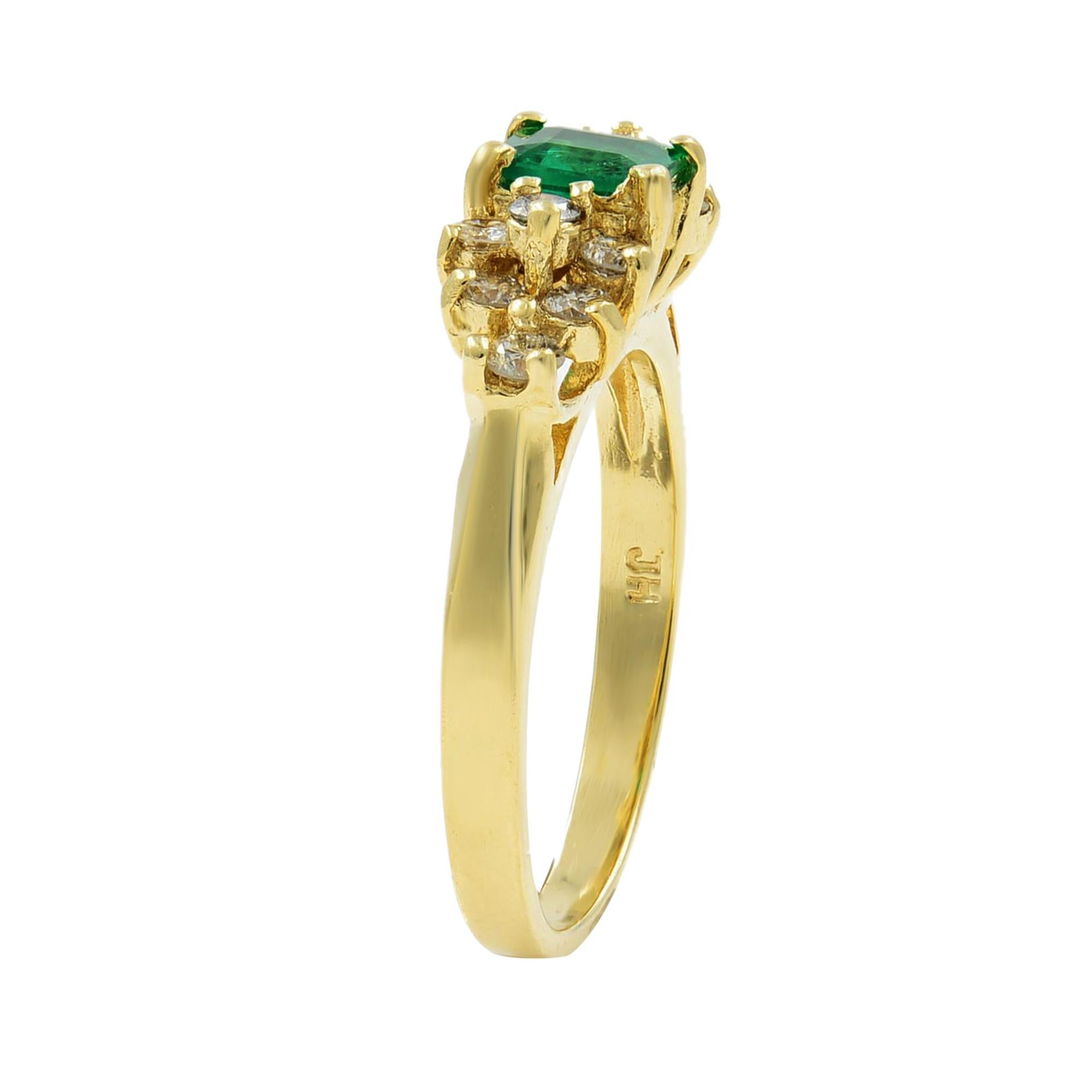 Sweet and rather petite, a rich green emerald-cut green emerald weighing 0.60ct is surrounded and flanked by 12 bright and sparkling round brilliant-cut diamonds weighing 0.36ct. This delightful estate jewel is presented in rich and sturdy 14K