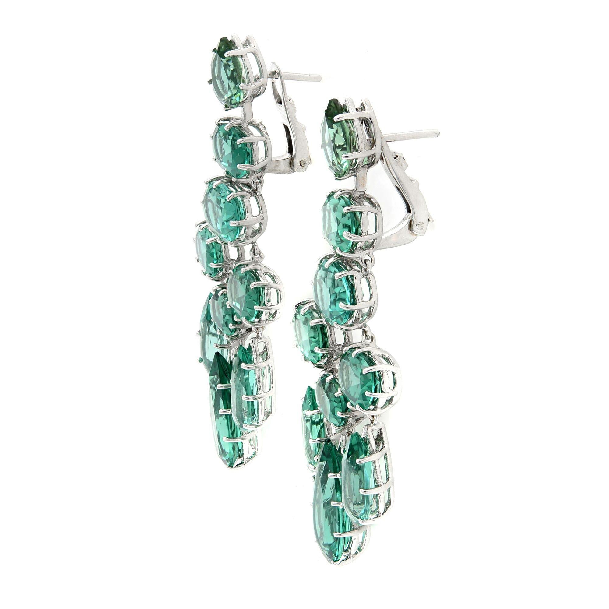 Dramatic yet elegant pair of Green Quartz chandelier drop earrings. Crafted in 14k white gold. Green Quartz weighs: 24.82 carats. Drop length: 2 inches. Closure: French Clip. Total weight: 15.44 grams. Comes with a presentable gift box. 