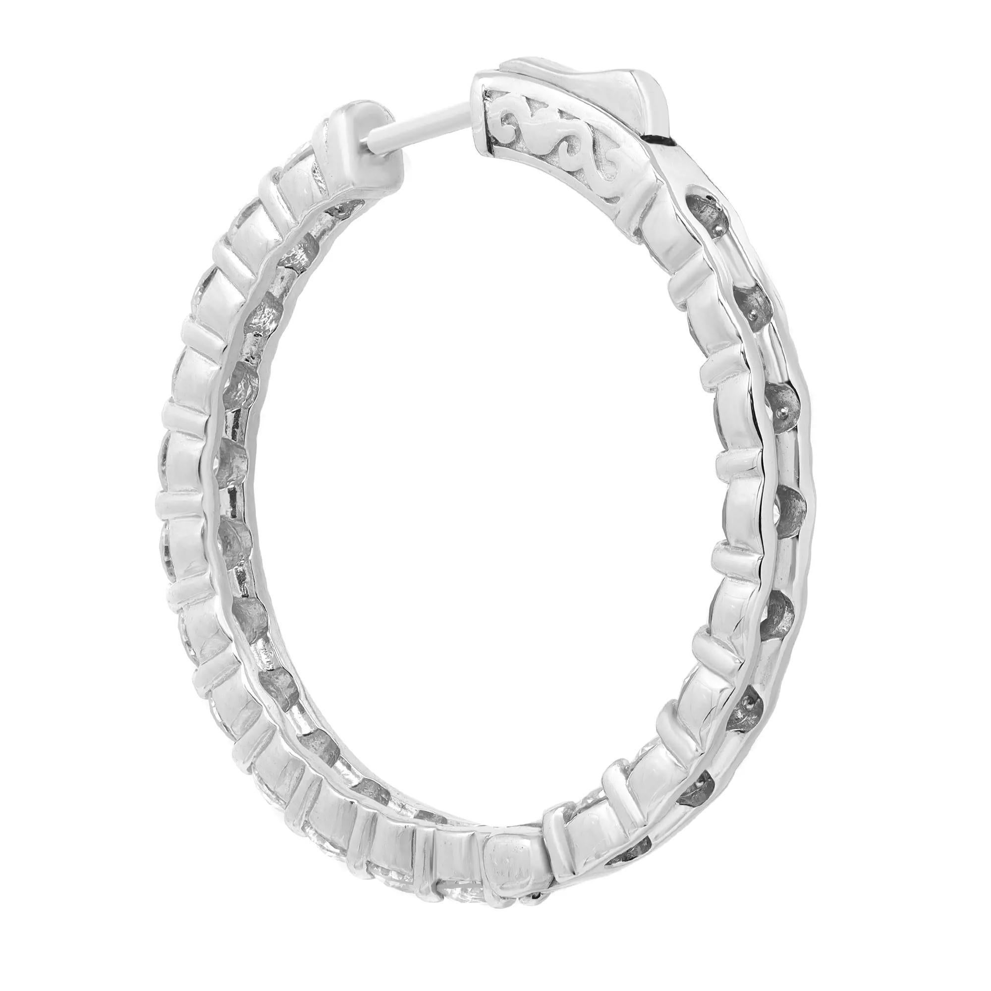 These stylish and elegant 14k white gold hoop earrings feature 40 prong-set round brilliant cut diamonds in a single line. The diamonds embellish these earrings on the inside and the outside, offering a dazzling look from every angle. Total diamond