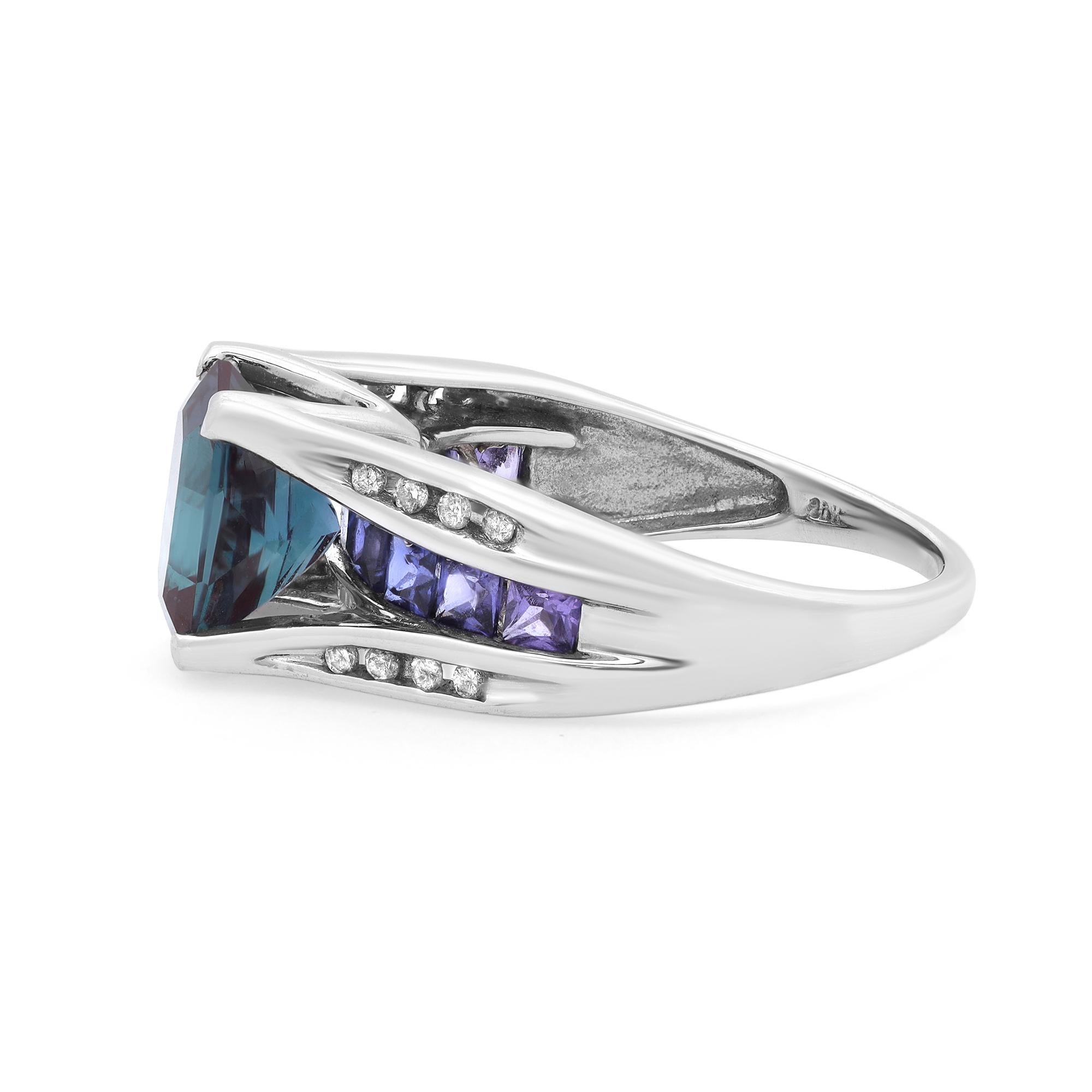 This beautiful ladies band ring features a prong set center Alexandrite with square-shaped Corrundum and round cut diamonds encrusted halfway through the band. Crafted in high polished 10K white gold. The ring size is 7. Total weight: 5.45 grams.