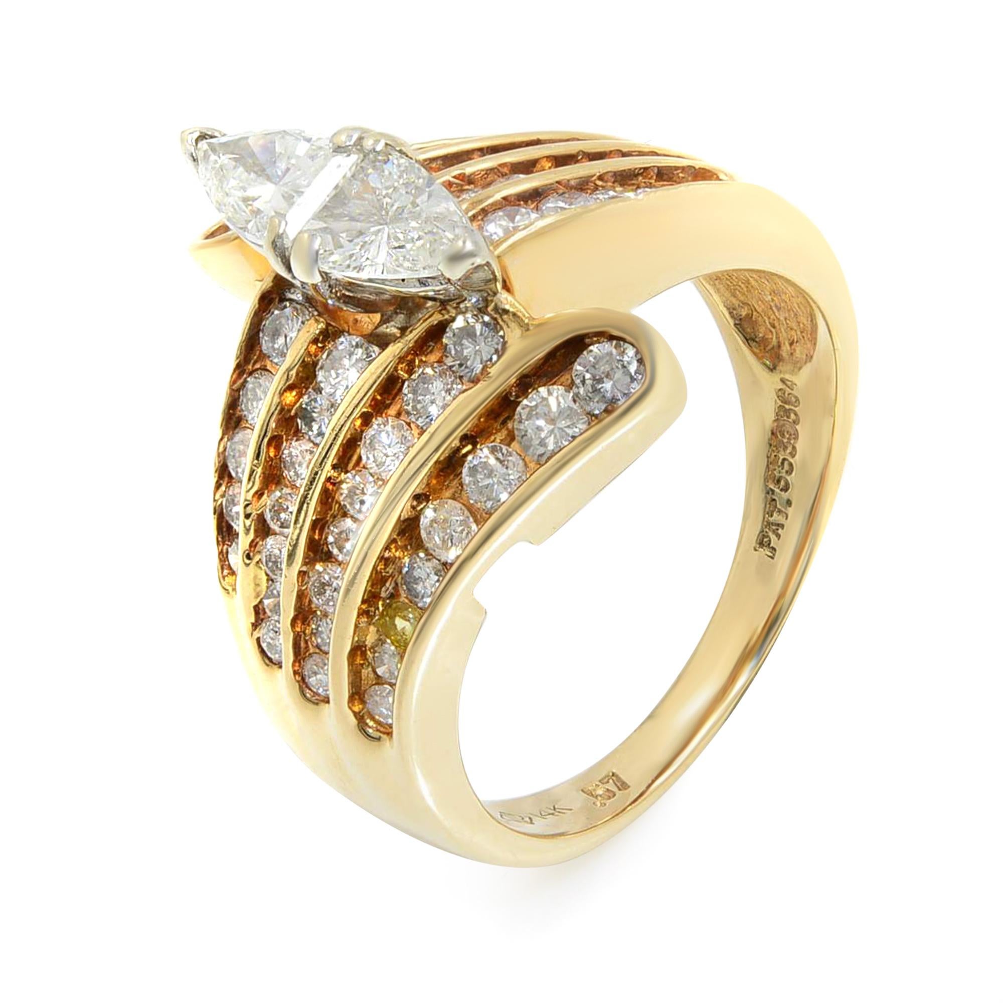 This gorgeous ring features a Marquise Illusion center diamond setting. The ring is accented with 4 rows of round cut diamonds on each side in channel setting. Crafted in high polished 14K Yellow Gold. Center marquise illusion is combined from 2