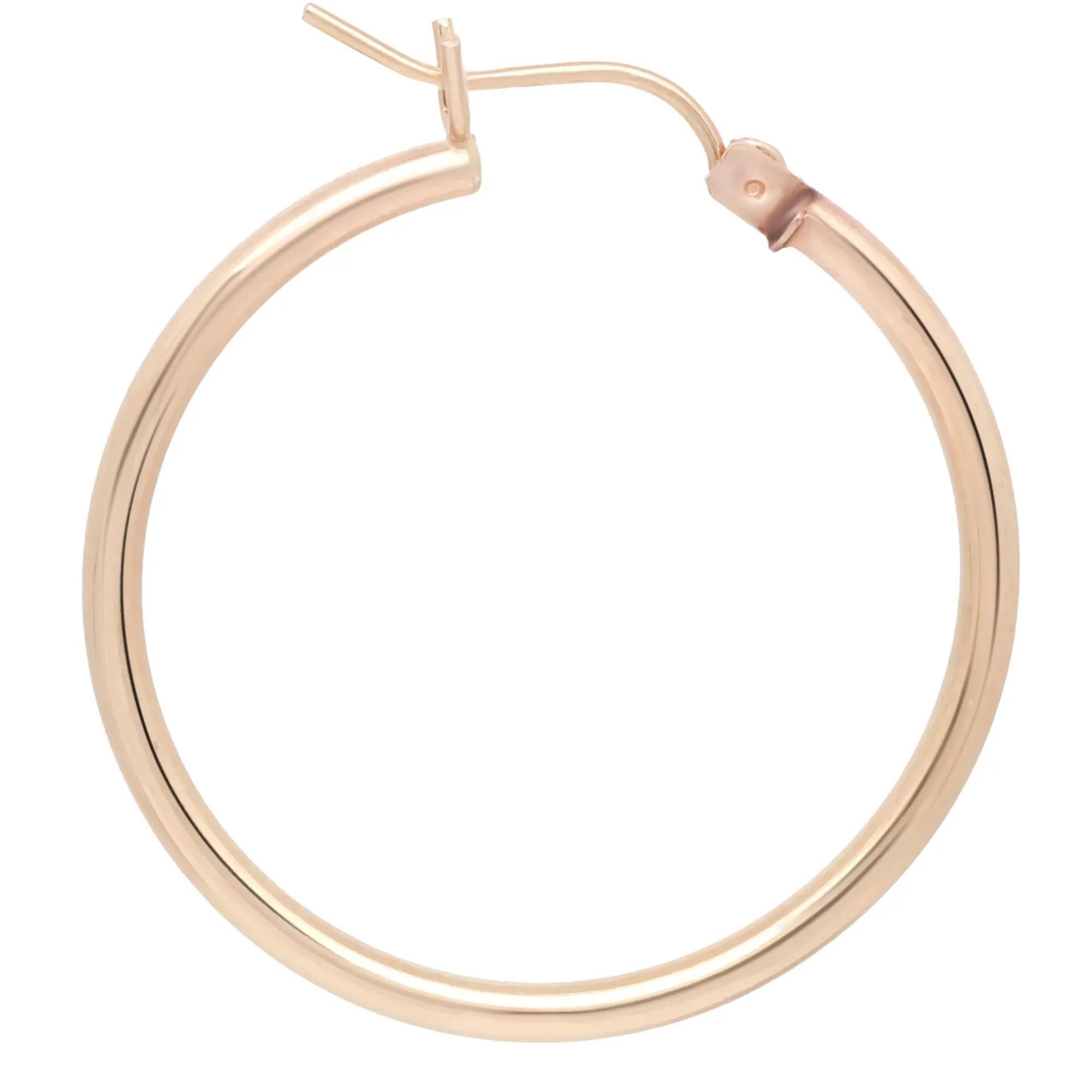 These medium round hoop earrings are crafted in 14k yellow gold and feature a majestic glow of high polish finish. This pair of hoop earrings will make a fashion statement and definitely be an eye catching pair. Size: 1.1 inches. Width: 2mm.