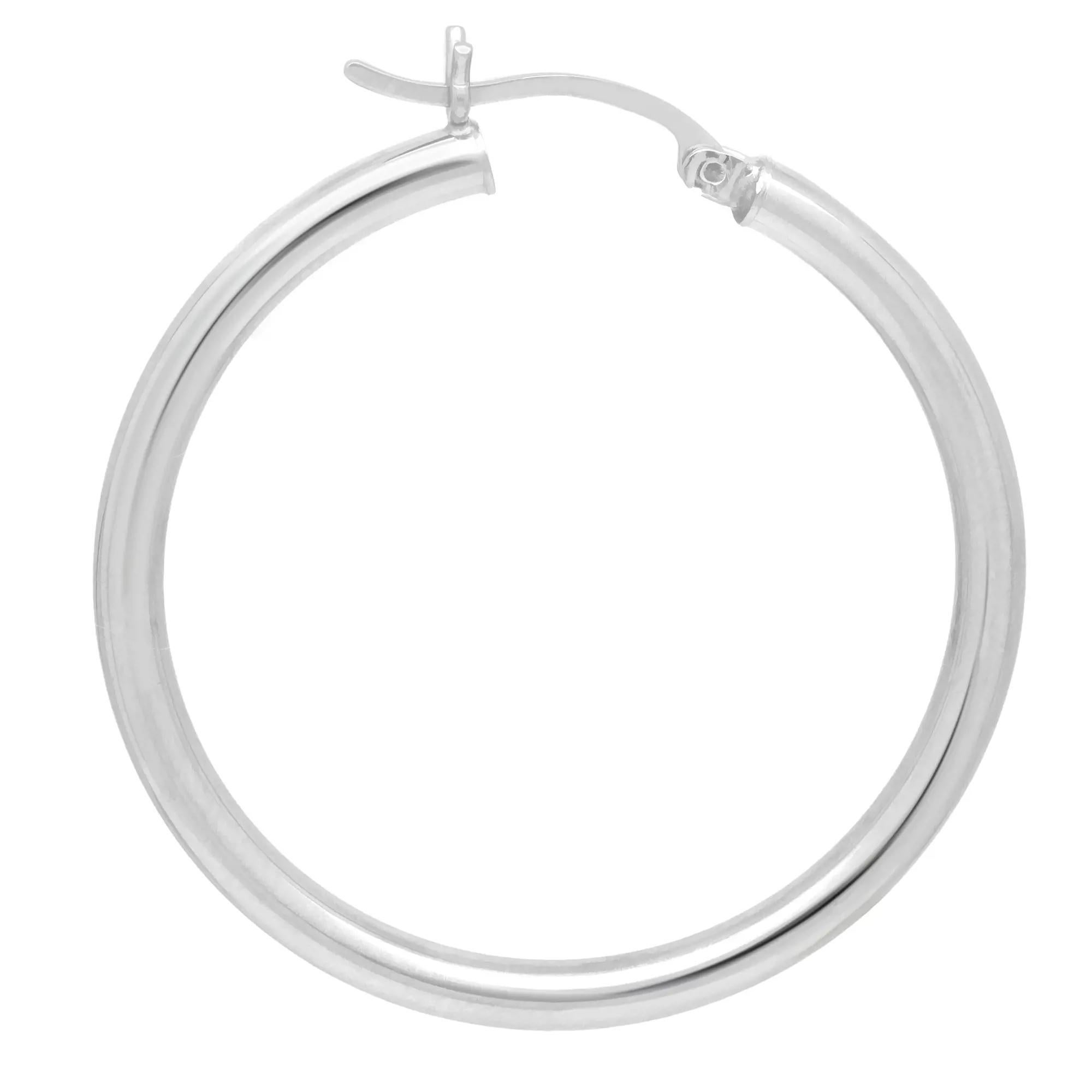 These medium round hoop earrings are crafted in 14k white gold and feature a majestic glow of high polish finish. This pair of hoop earrings will make a fashion statement and definitely be an eye catching pair. Size: 1.4 inches. Width: 3.1mm.