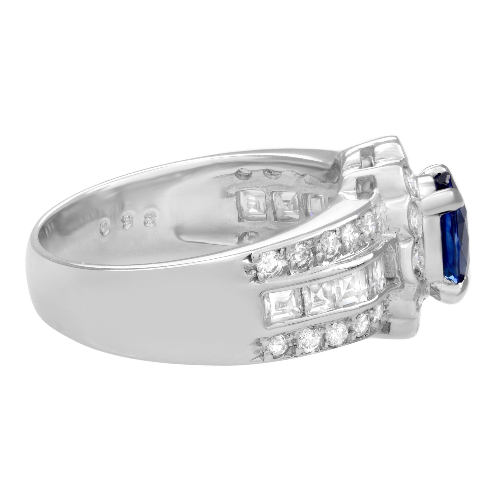 This beautiful cocktail ring features a center oval cut Blue Sapphire weighing 1.02cts surrounded by round brilliant cut and princess cut diamonds alternating between pave set and channel set in each row. Crafted in highly polished platinum with