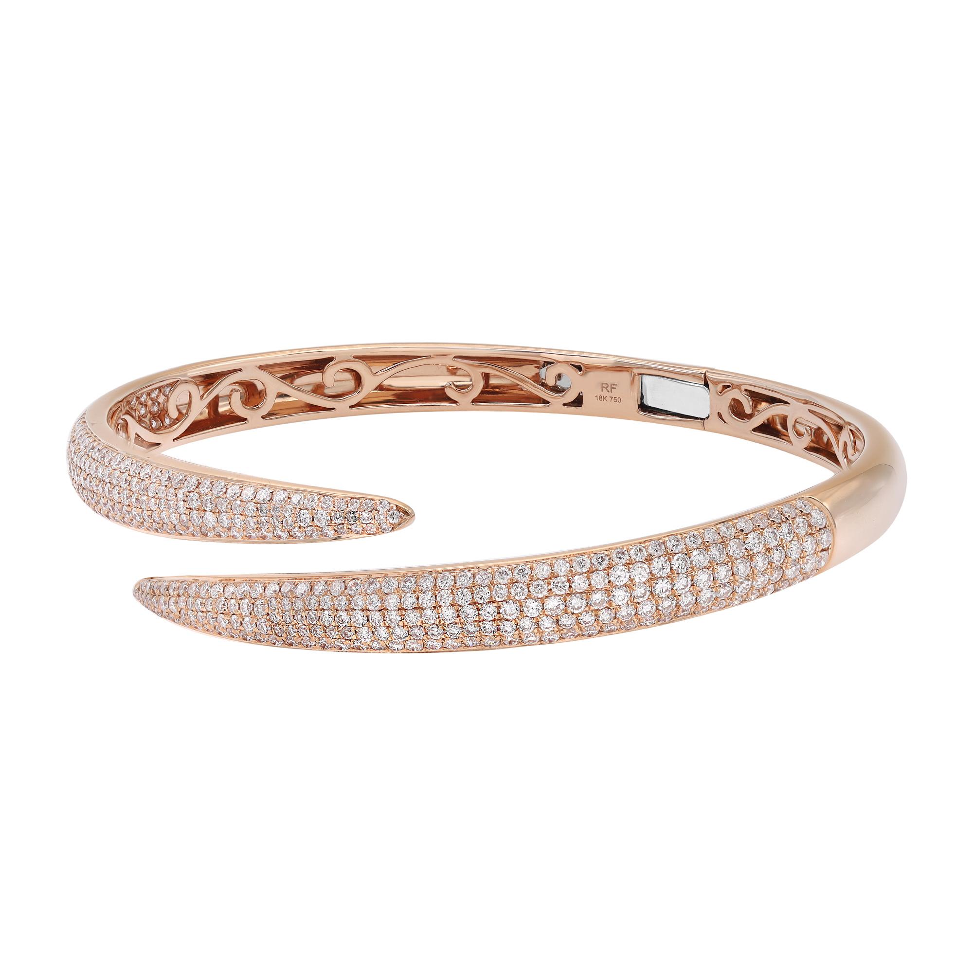 A classic look with easy elegance, this diamond bangle bracelet exudes sophistication. This stunning bracelet is crafted in 18k rose gold and features pave set tiny white round cut diamonds with a total weight of 2.68 carats. Diamond color G-H and