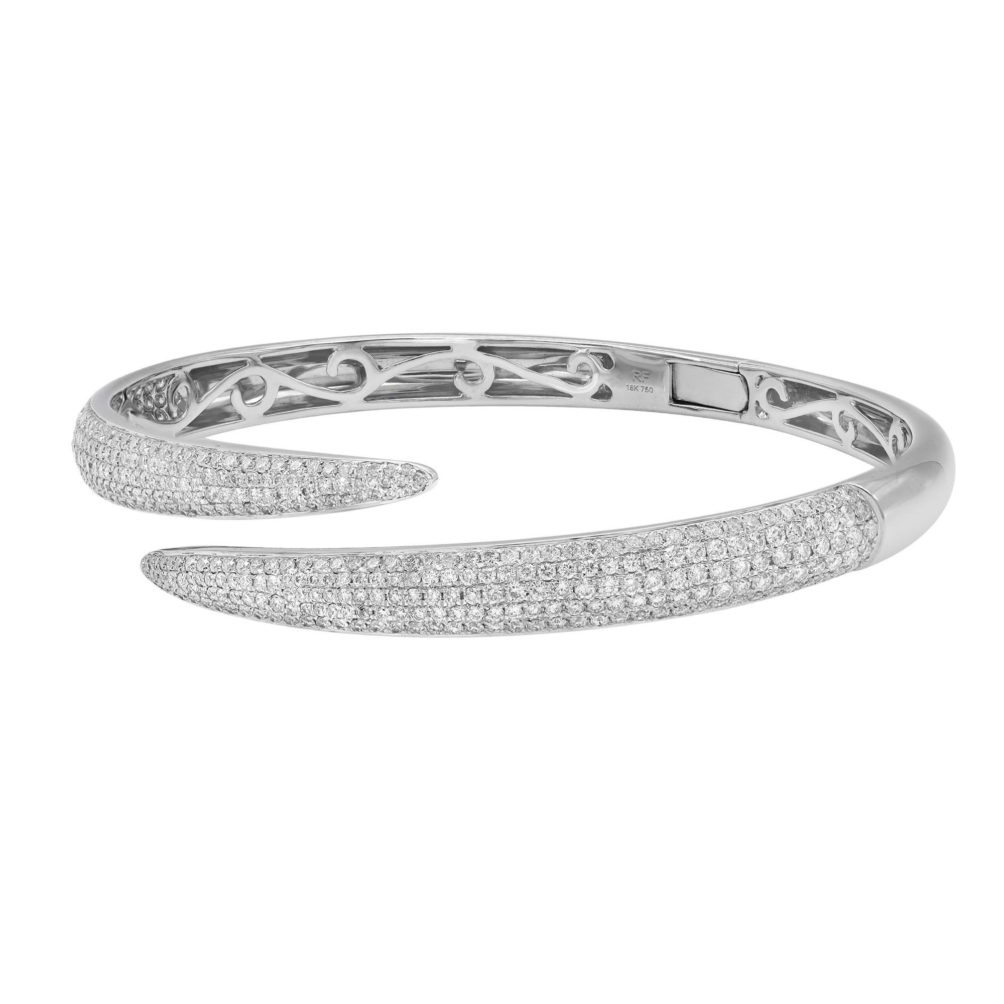 A classic look with easy elegance, this diamond bangle bracelet exudes sophistication. This stunning bracelet is crafted in 18k white gold and features pave set tiny white round cut diamonds with a total weight of 2.64 carats. Diamond color G-H and