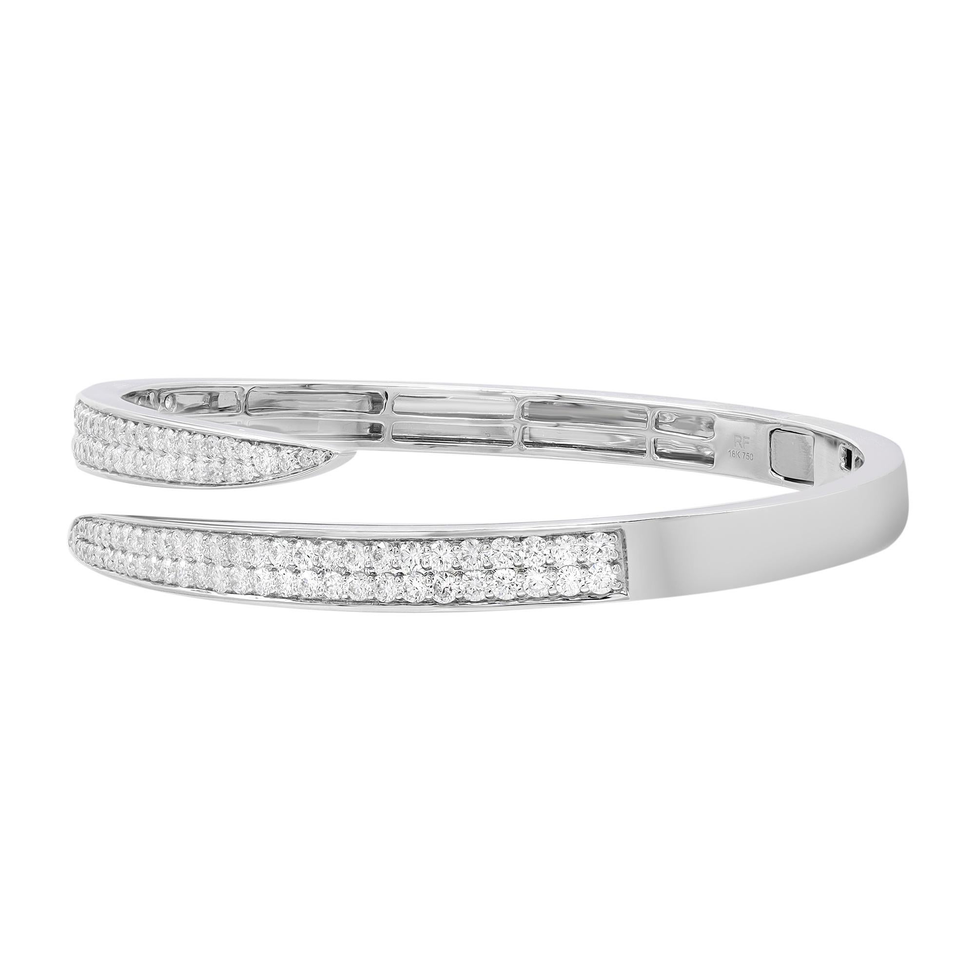Let your style shine with this fancy and elegant diamond bangle bracelet. Encrusted with pave set bright white natural round cut diamonds set halfway through the bangle. Crafted in fine high polished 18k white gold. The total diamond weight is 2.99