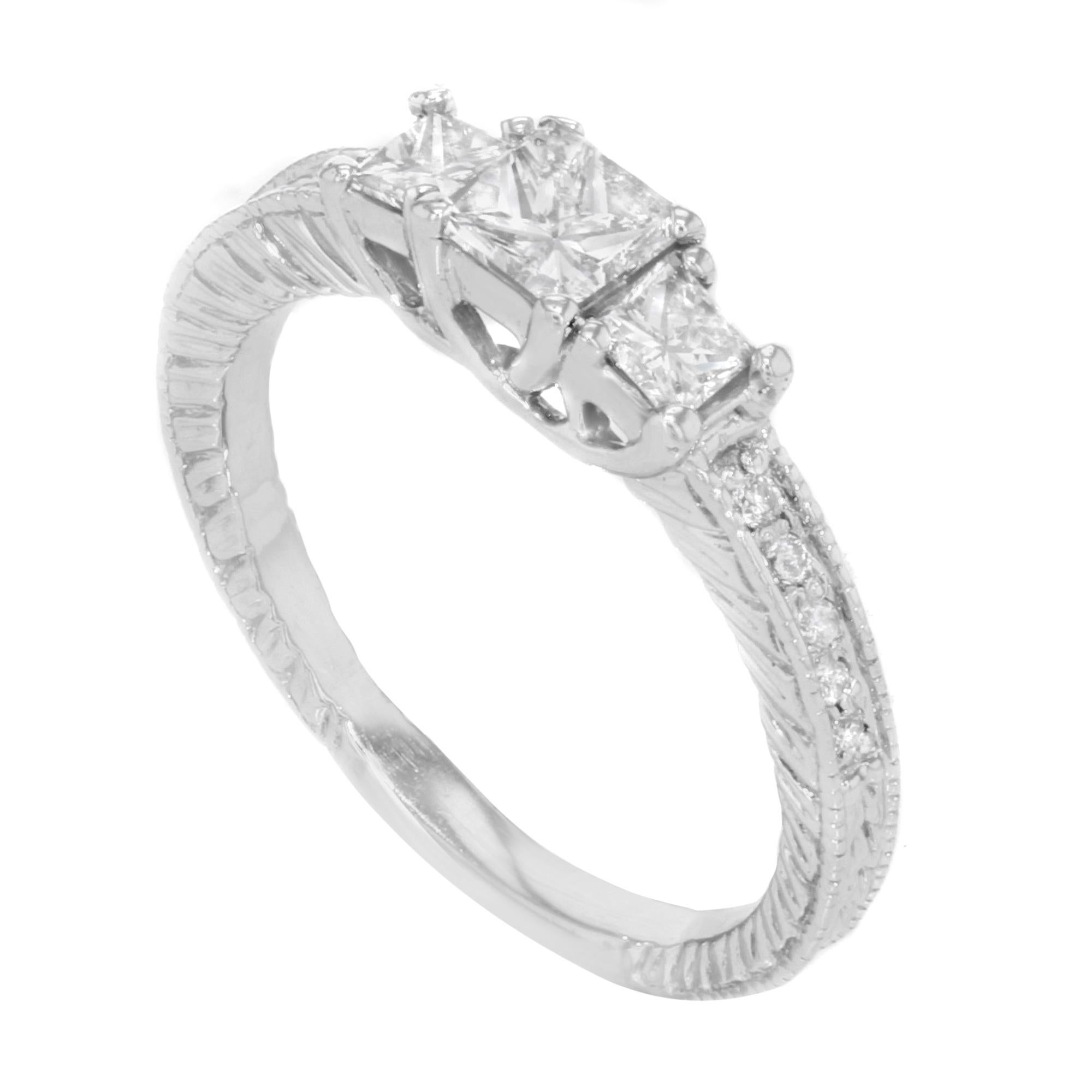 This beautiful ring is crafted in 14K white gold with approximately 1.00cttw of dazzling princess cut diamonds with tiny round cut diamonds. The color of stones is G-H and clarity VS-SI. The center stone weighs 0.40ct. Ring size: 7. Total weight: