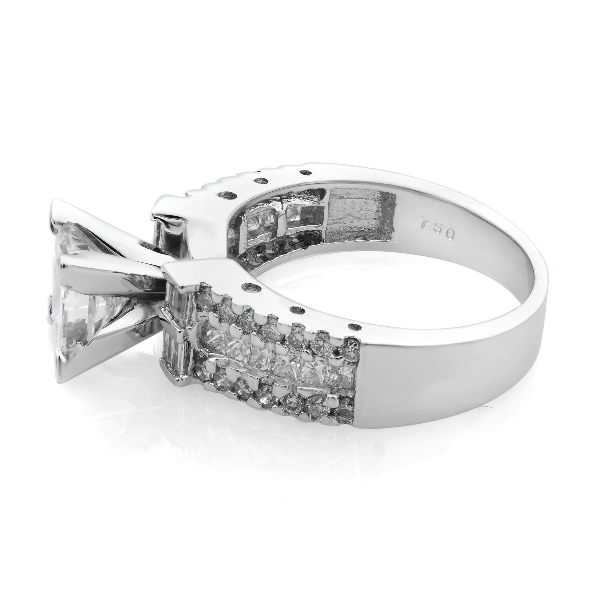 This amazing engagement ring is set in 18 karat white gold and features 1.25 carat princess cut as a center stone with round, baguette and princess cuts on a shank. The total diamond weight is approximately 2.20 carats. Diamonds are SI2 clarity and