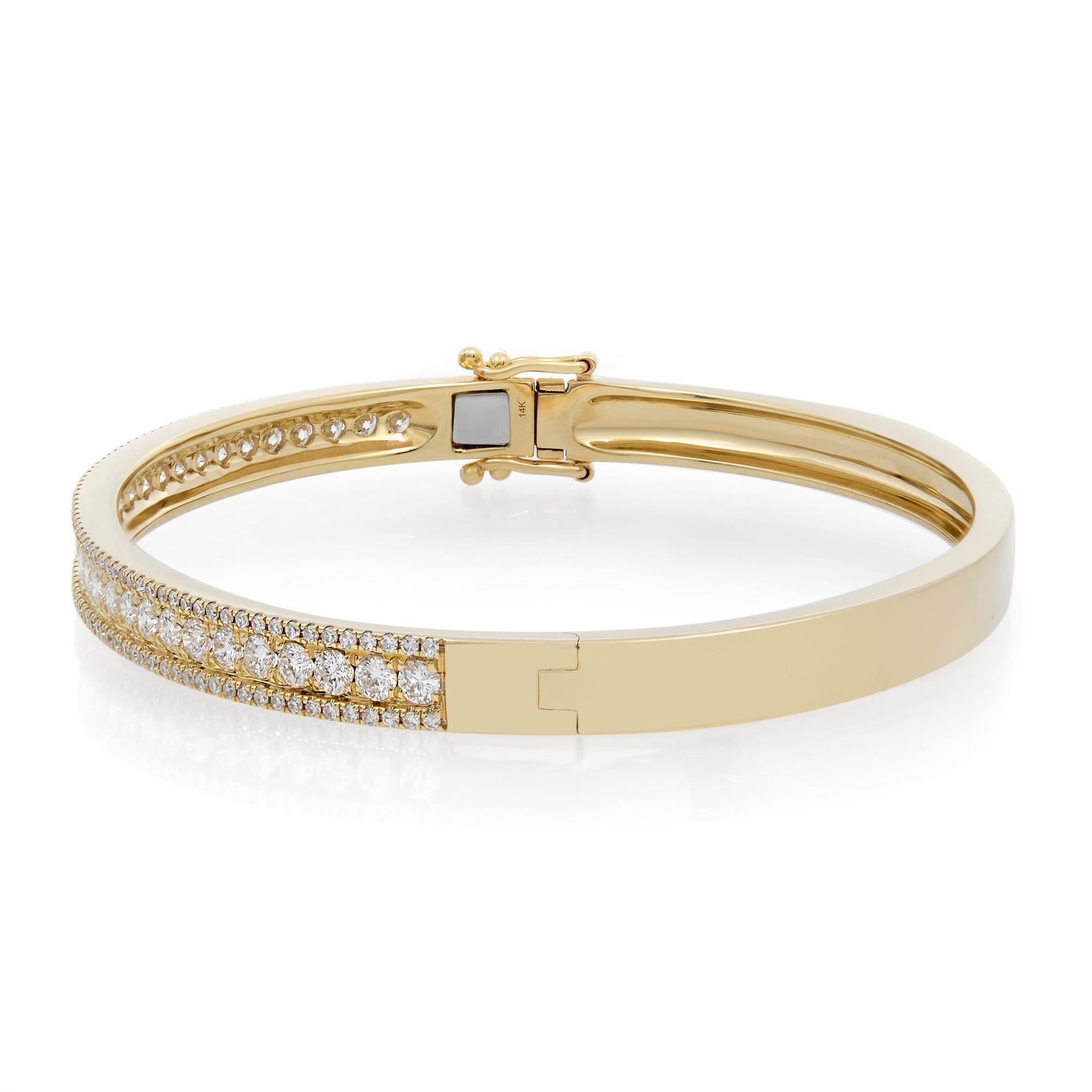 This stunning and exemplary bracelet is crafted in high polished 14K yellow gold. Starring sparkling radiant pave set round cut diamonds weighing 1.70 carats in total. Set halfway through the bangle. Diamond color G-H and clarity VS-SI. It's