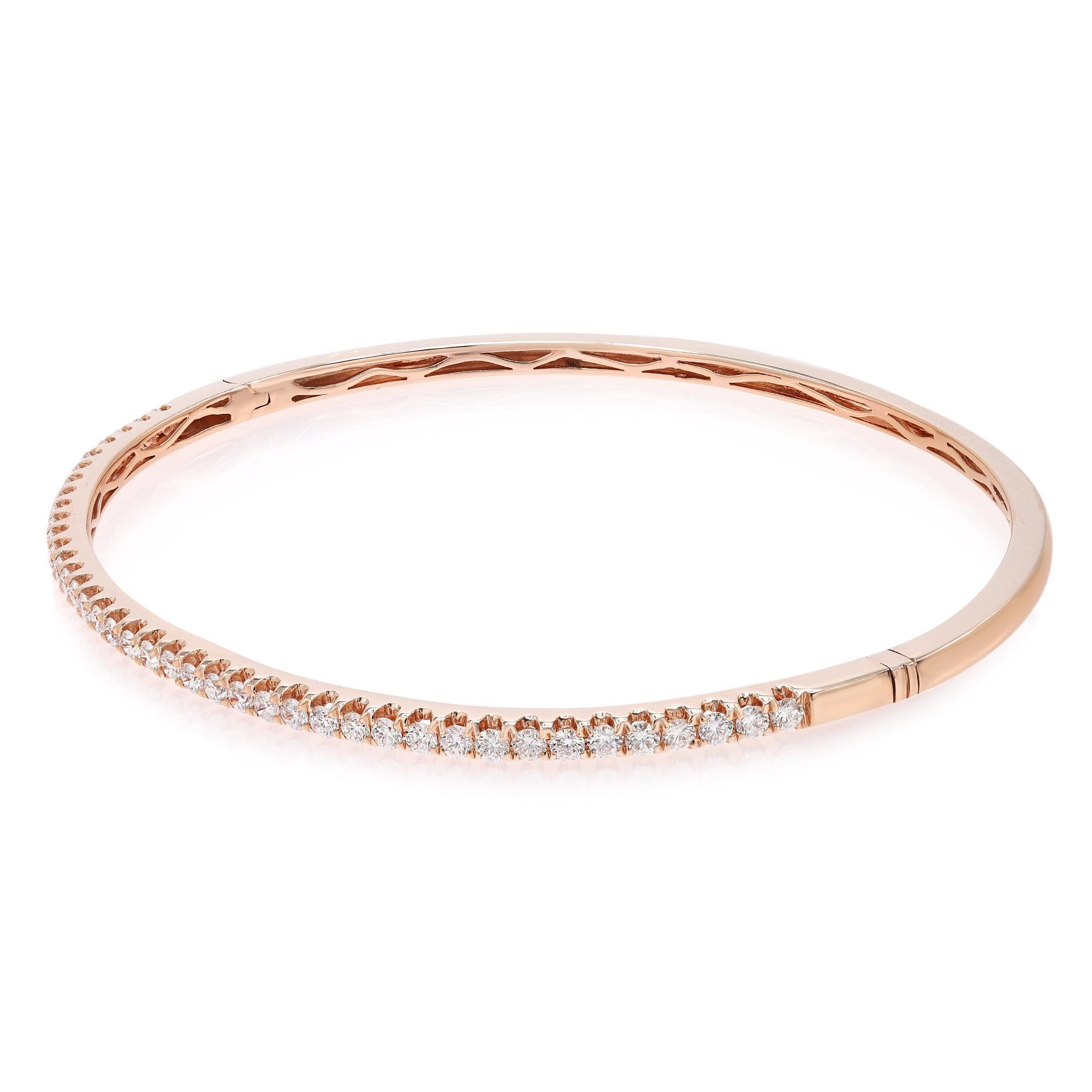This beautifully crafted bangle bracelet features round brilliant cut diamonds set halfway through the bangle in four prong setting. Crafted in 18k rose gold. Total diamond weight: 0.99 carats. Diamond Quality: F-G color and SI clarity. Wrist size:
