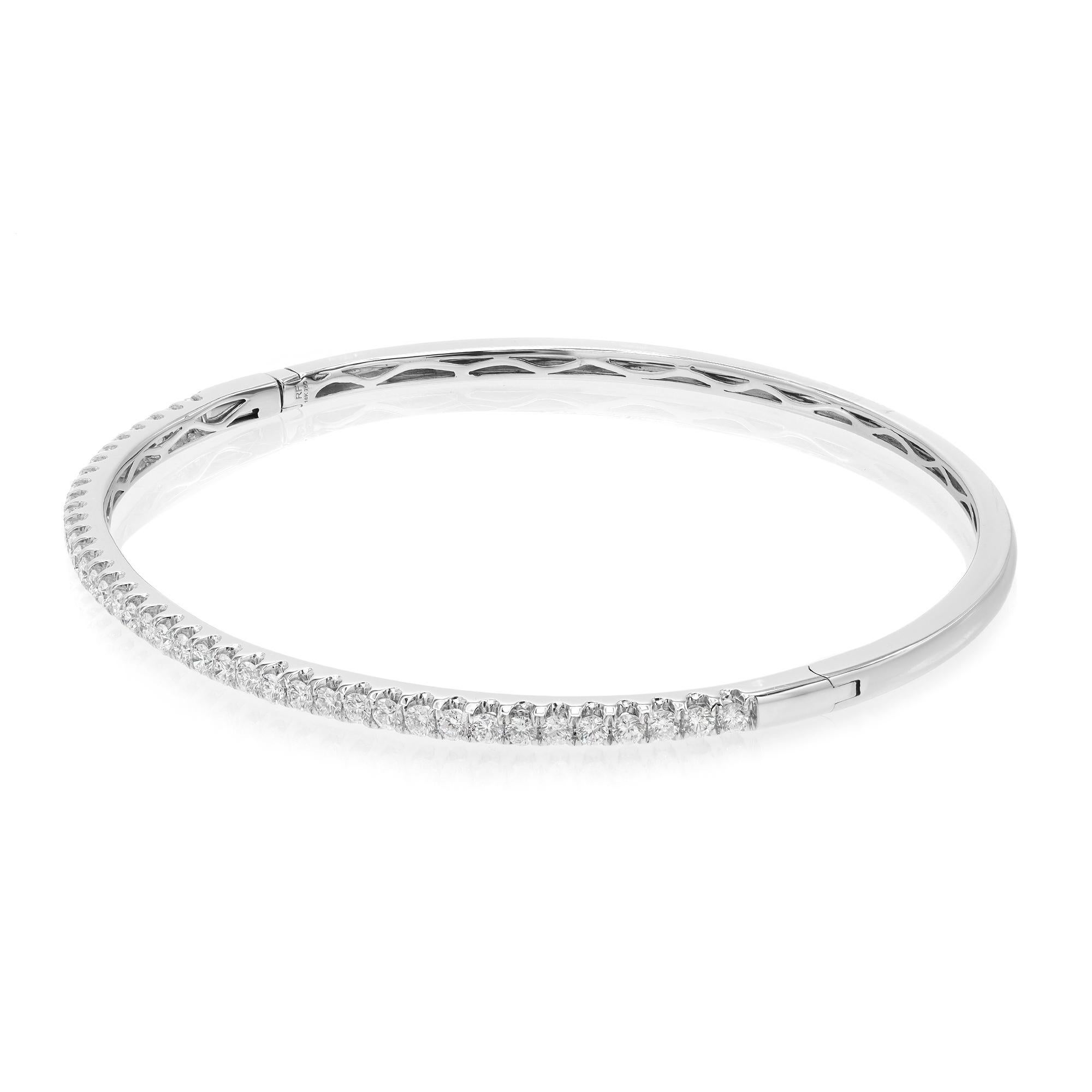 This beautifully crafted bangle bracelet features round brilliant cut diamonds set halfway through the bangle in four prong setting. Crafted in 18k white gold. Total diamond weight: 0.99 carat. Diamond Quality: F-G color and SI clarity. Wrist size: