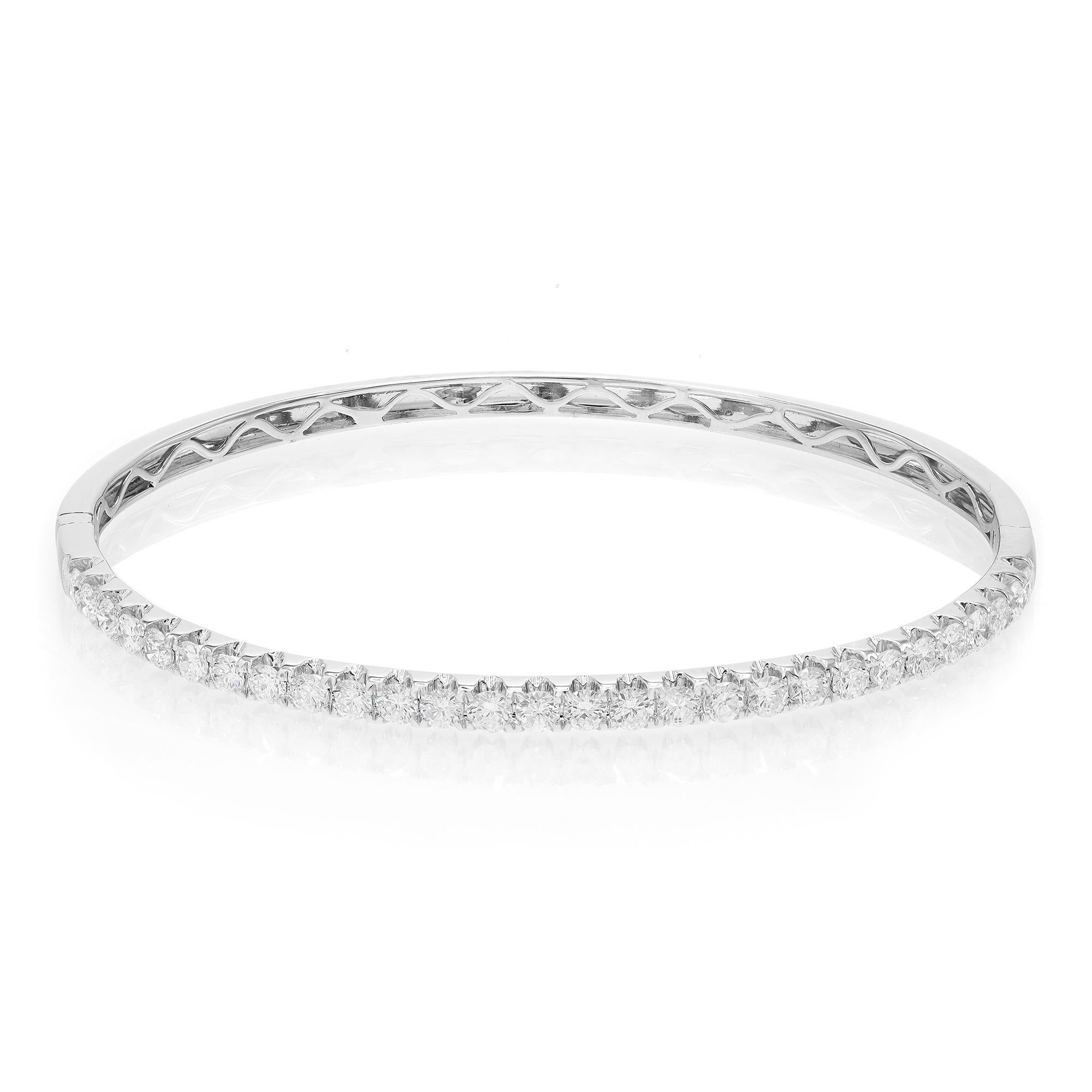 This beautifully crafted bangle bracelet features round brilliant cut diamonds encrusted halfway through the bangle in four prong setting. Crafted in 18k white gold. Total diamond weight: 2.00 carats. Diamond Quality: F-G color and SI clarity. Wrist