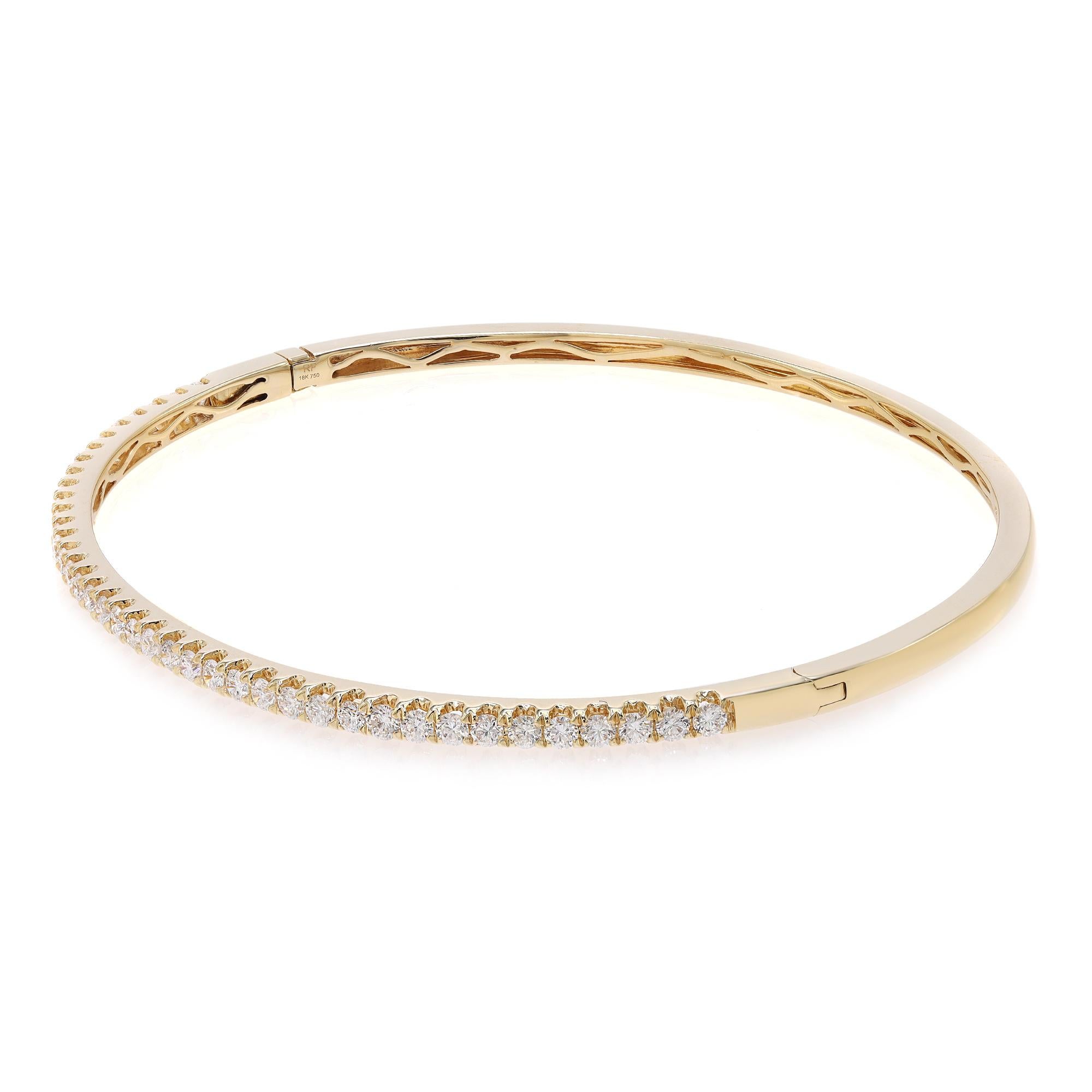 This beautifully crafted bangle bracelet features round brilliant cut diamonds set halfway through the bangle in four prong setting. Crafted in 18k yellow gold. Total diamond weight: 1.00 carats. Diamond Quality: F-G color and SI clarity. Wrist