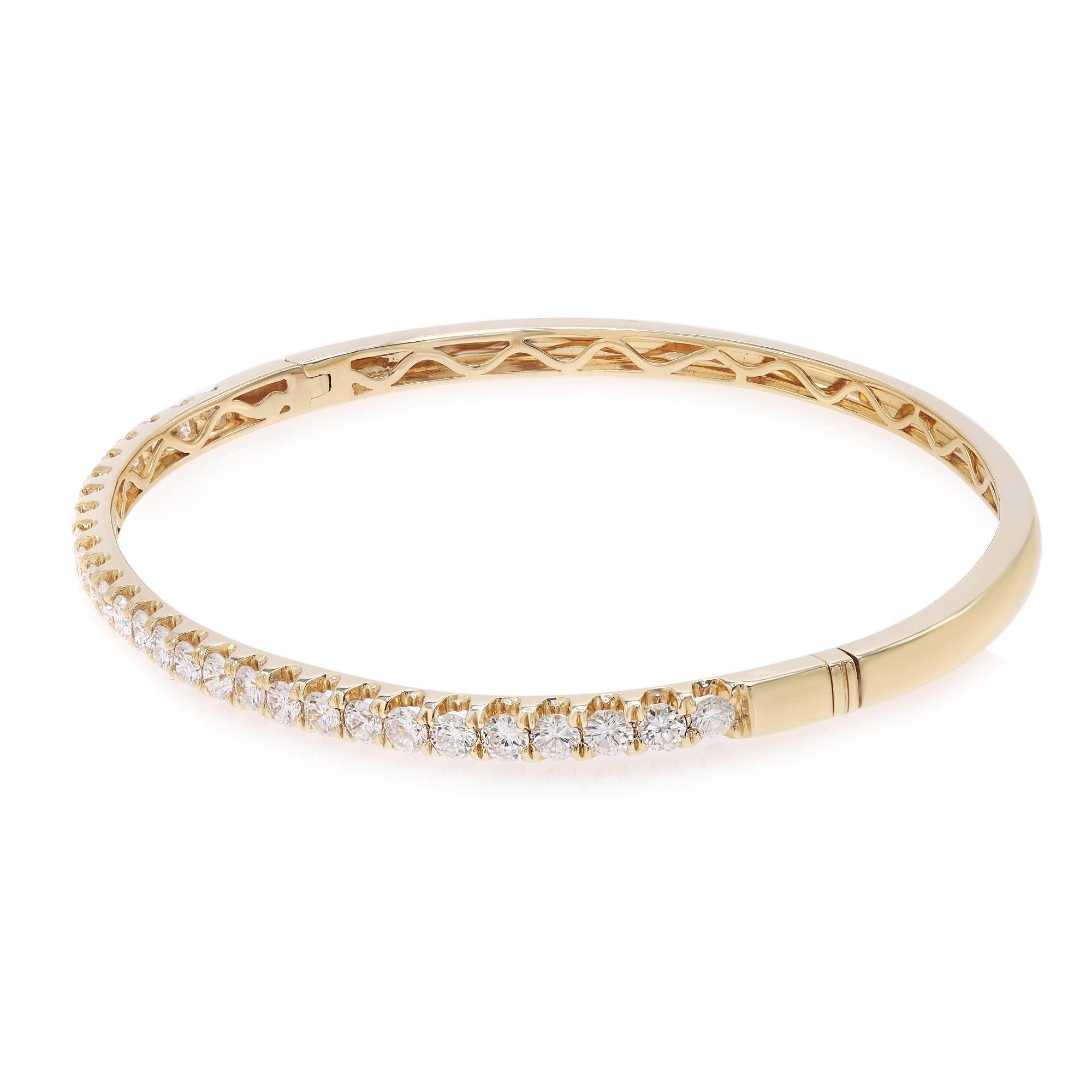 This beautifully crafted bangle bracelet features round brilliant cut diamonds encrusted halfway through the bangle in four prong setting. Crafted in 18k yellow gold. Total diamond weight: 2.00 carats. Diamond Quality: F-G color and SI clarity.