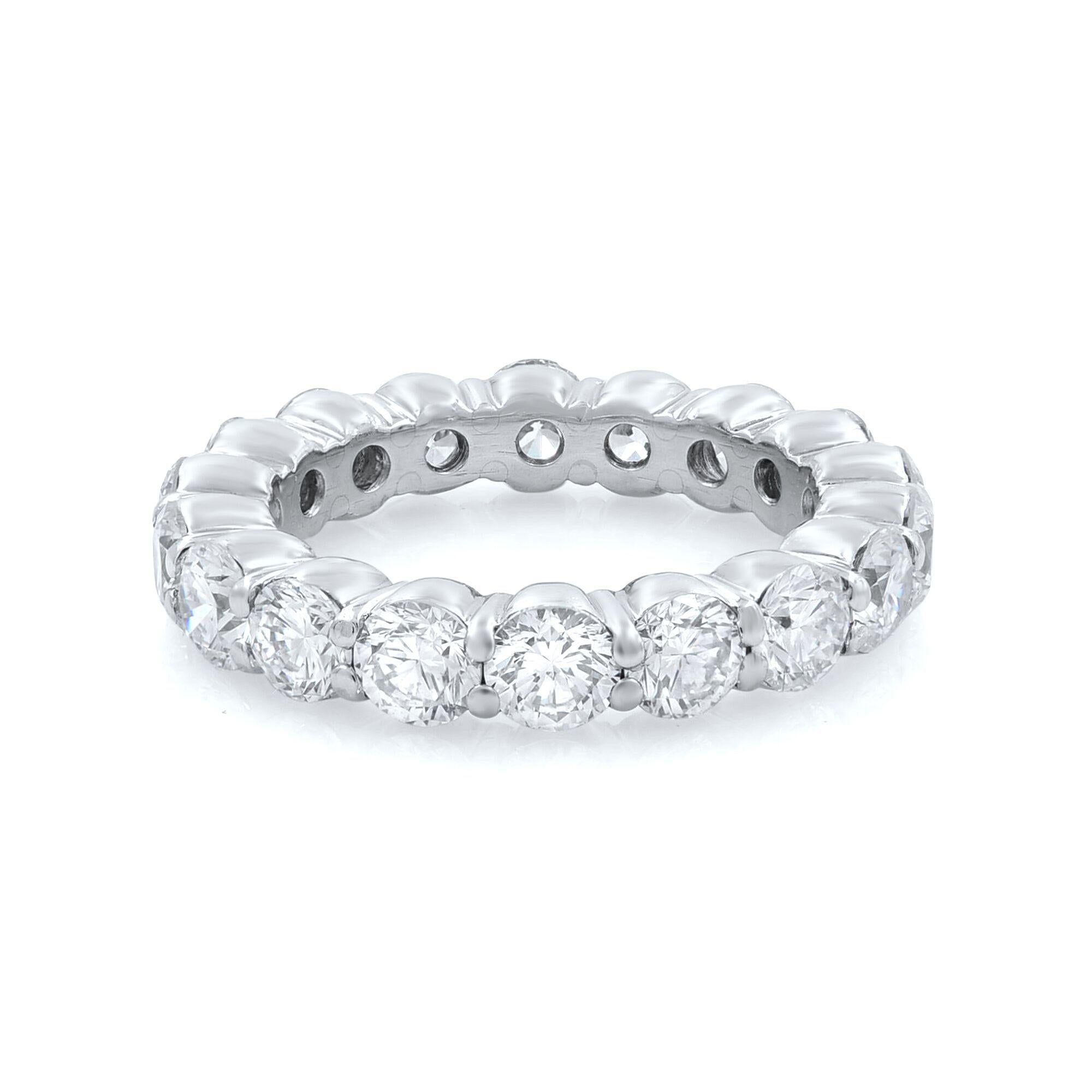Eighteen brilliant-cut round bright near-colorless diamonds of F-G color, VS-SI clarity circle all the way around this unique contemporary diamond eternity ring band for women. The stones are elegantly set in a shiny Platinum shared-prong basket