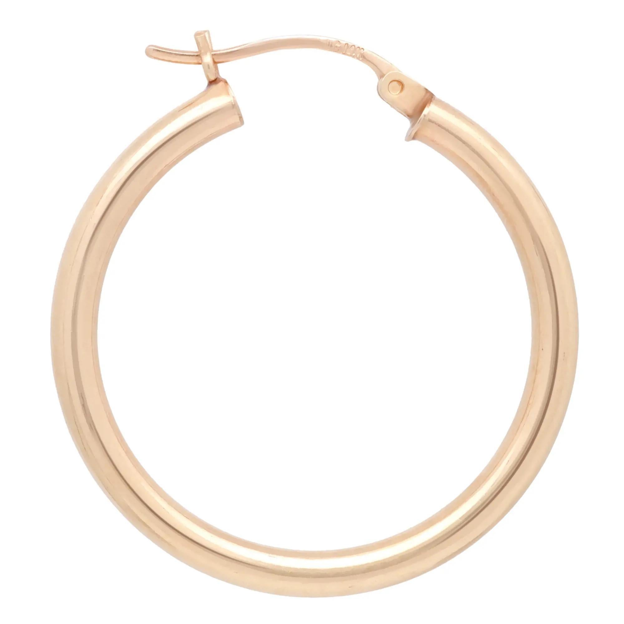 These medium round hoop earrings are crafted in 14k yellow gold and feature a majestic glow of high polish finish. This pair of hoop earrings will make a fashion statement and definitely be an eye catching pair. Size: 1.2 inches. Width: 3 mm.