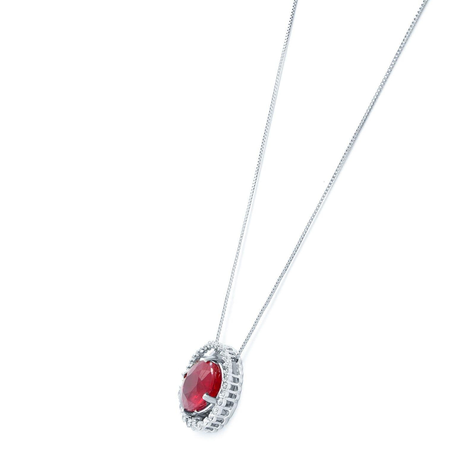 This gorgeous diamond ruby pendant necklace is crafted in 14K white gold. The pendant is set with 0.50ct of round cut natural diamonds and 7 carats of deep rich prong set oval cut ruby. Diamond color F and clarity VS. Necklace length: 17 inches.