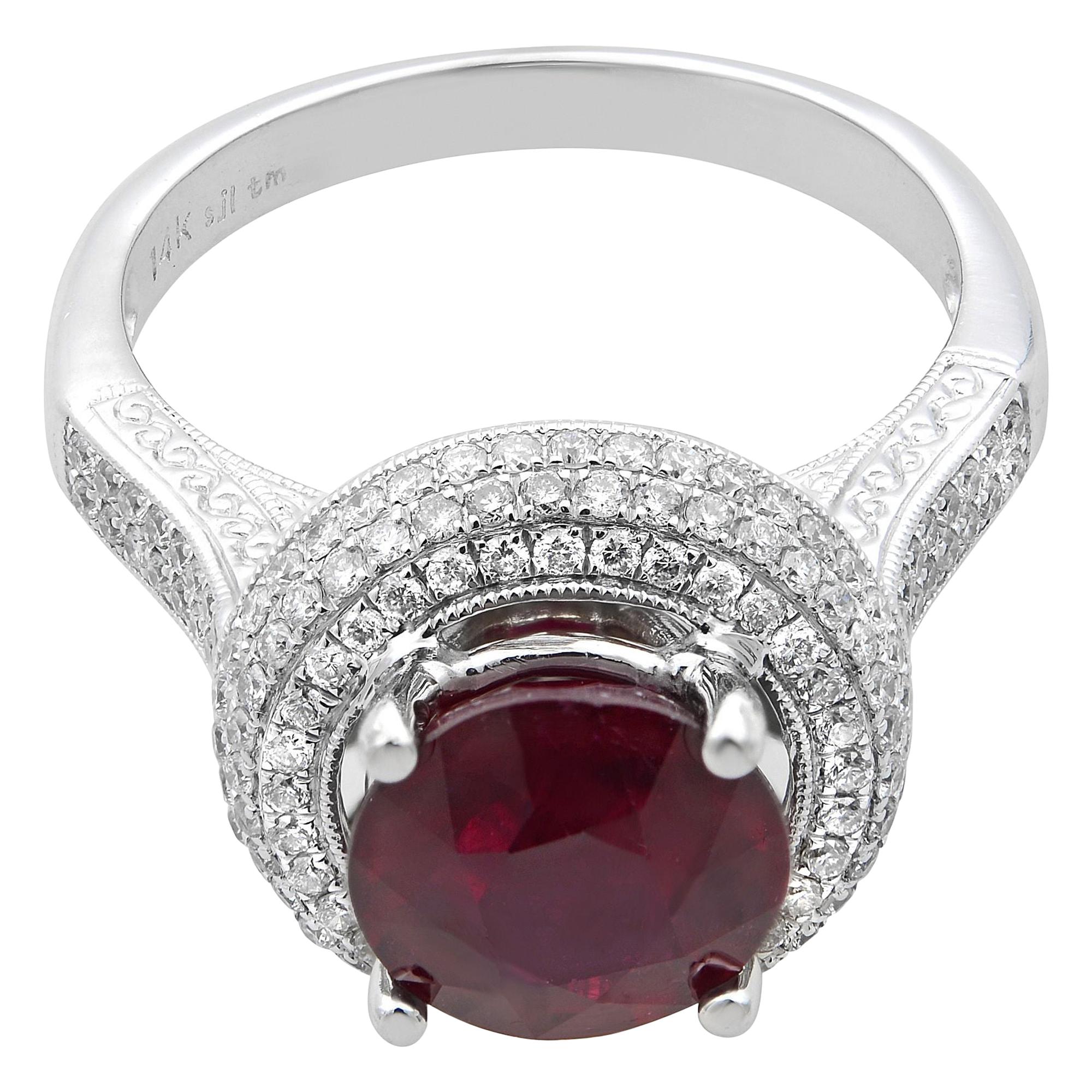 This beautiful round ruby and diamond engagement ring is crafted in fine 14k white gold. An excellent prong set round cut ruby is flanked as a center stone with tiny round cut diamonds weighing 0.75 carat. Ring Size 7.75. Total weight: 6 gms. Comes