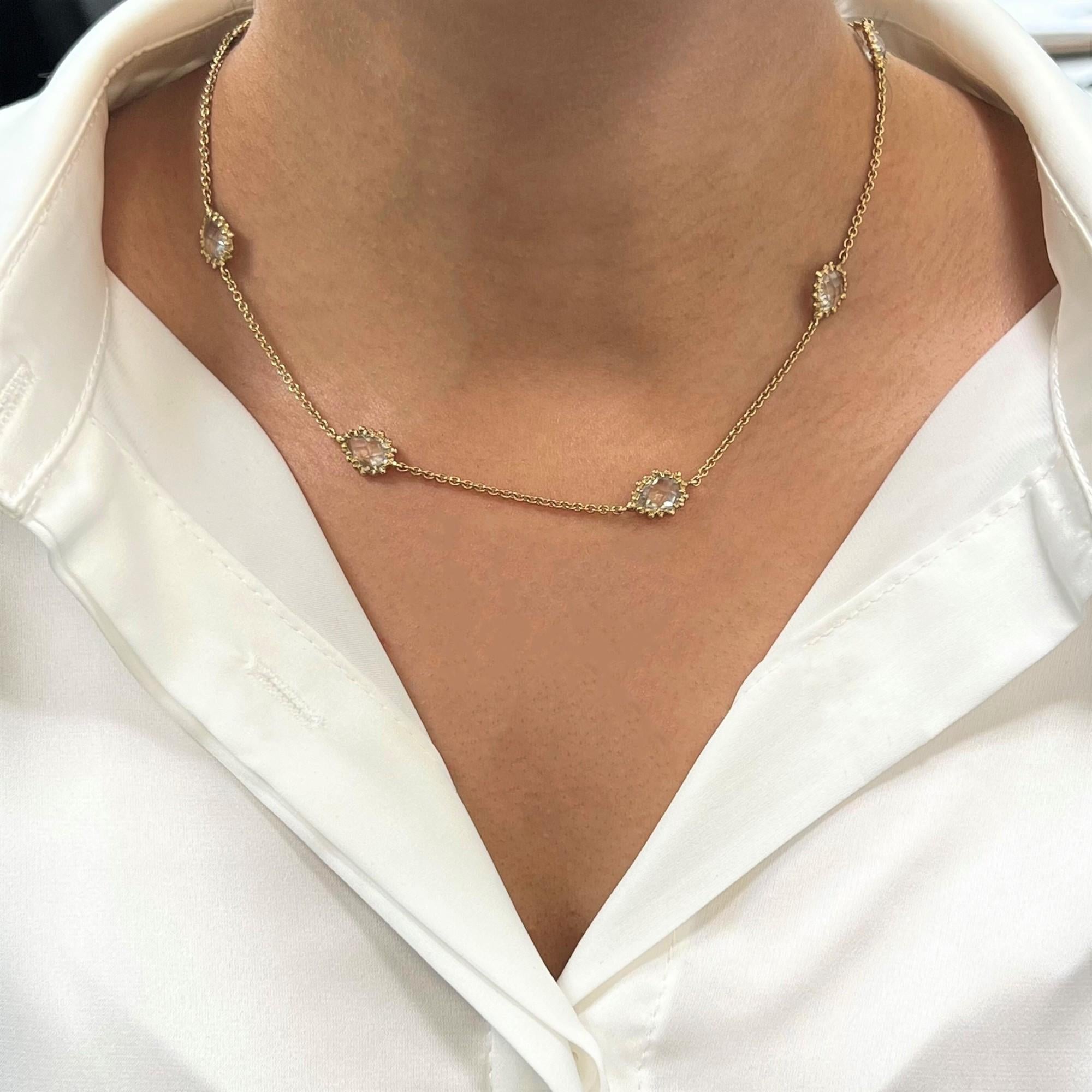 This necklace is crafted in 14k yellow gold and encrusted with 7 white clear quartz stones. The length of the necklace is 16 inches. Total weight: 5.6 gms. Comes with a gift box and an appraisal card.